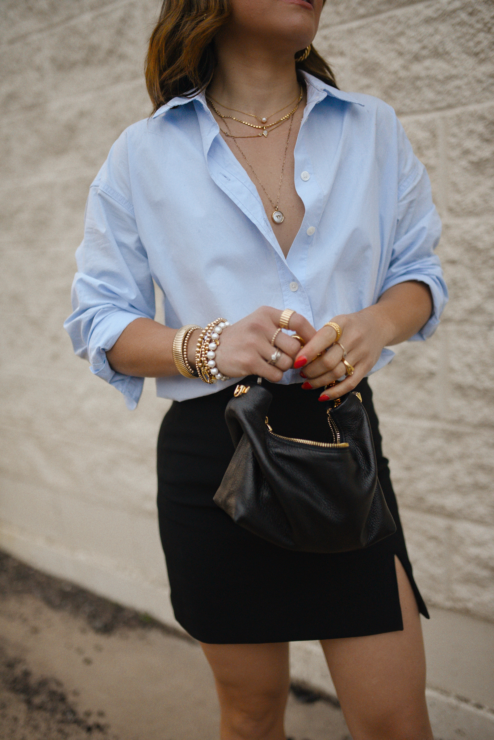 Carolina Hellal from Chic Talk wearing a Aritzia skirt, Target blue shirt, Dolce Vitta sandals and Jacquemus bag