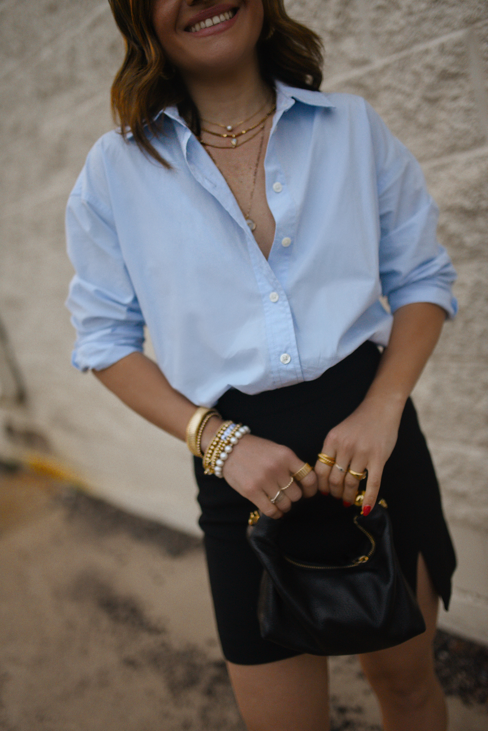 Carolina Hellal from Chic Talk wearing a Aritzia skirt, Target blue shirt, Dolce Vitta sandals and Jacquemus bag