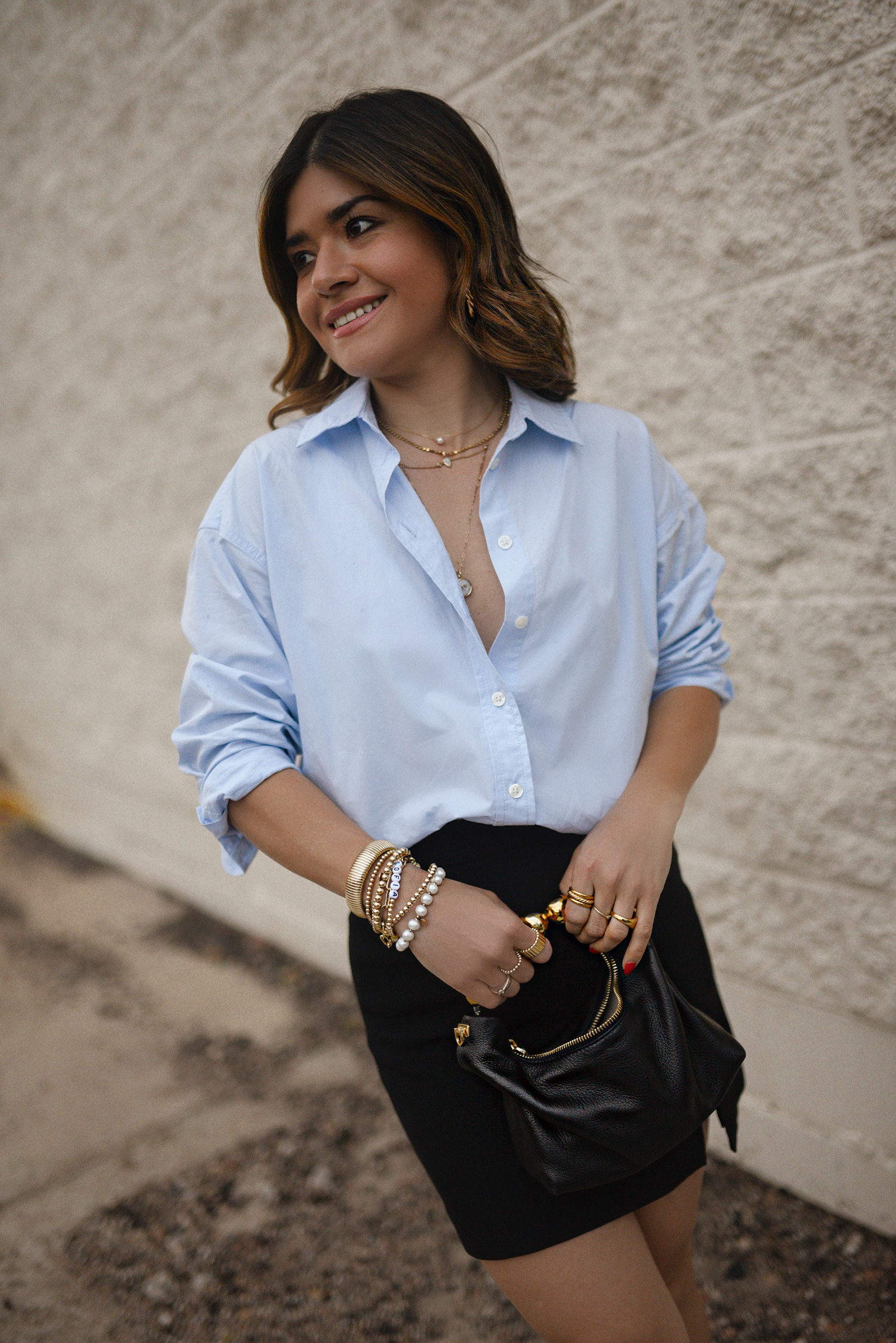 Carolina Hellal from Chic Talk wearing a Aritzia skirt, Target blue shirt, Dolce Vitta sandals and Jacquemus bag