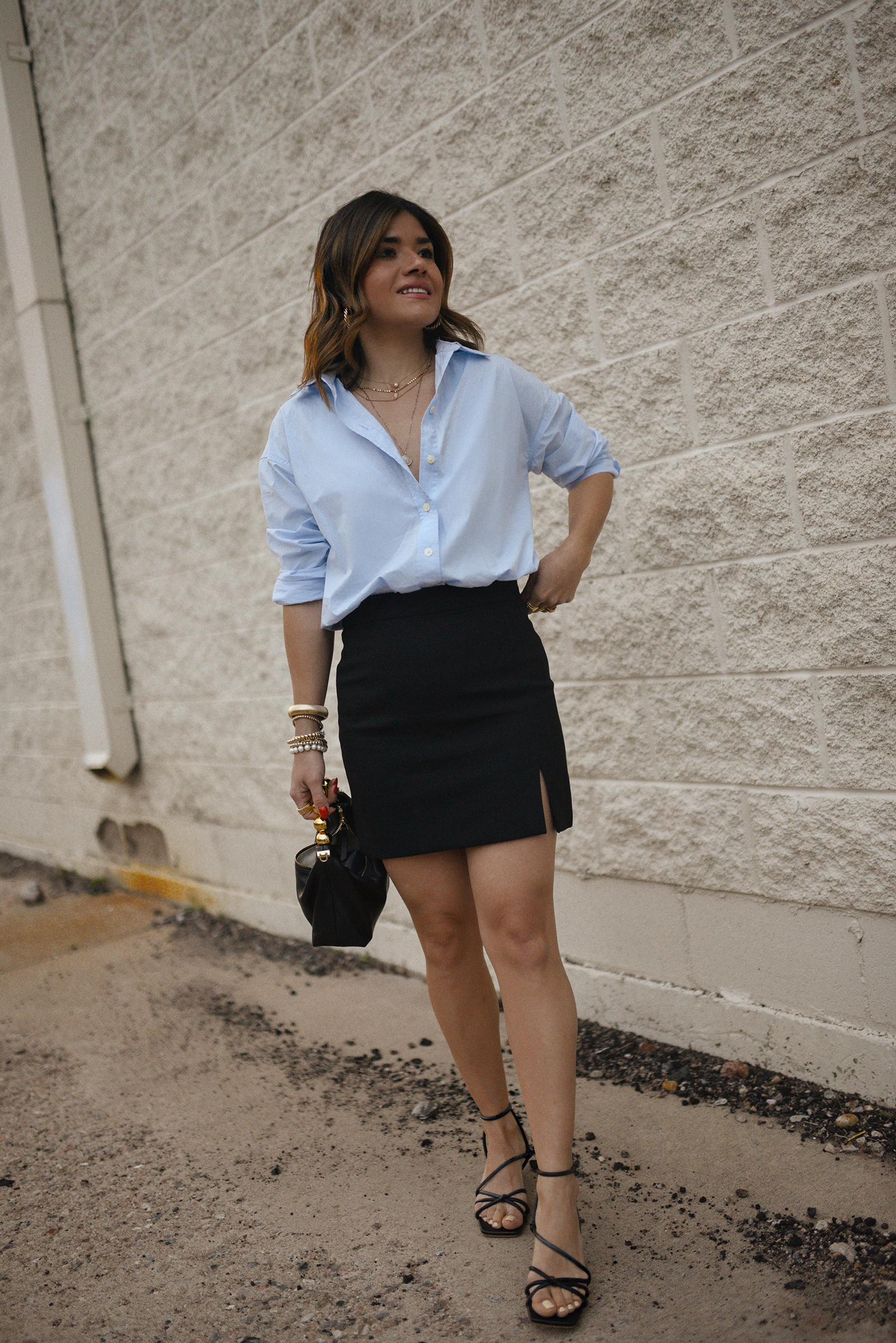 Carolina Hellal from Chic Talk wearing a Aritzia skirt, Target blue shirt, Dolce Vitta sandals and Jacquemus bag