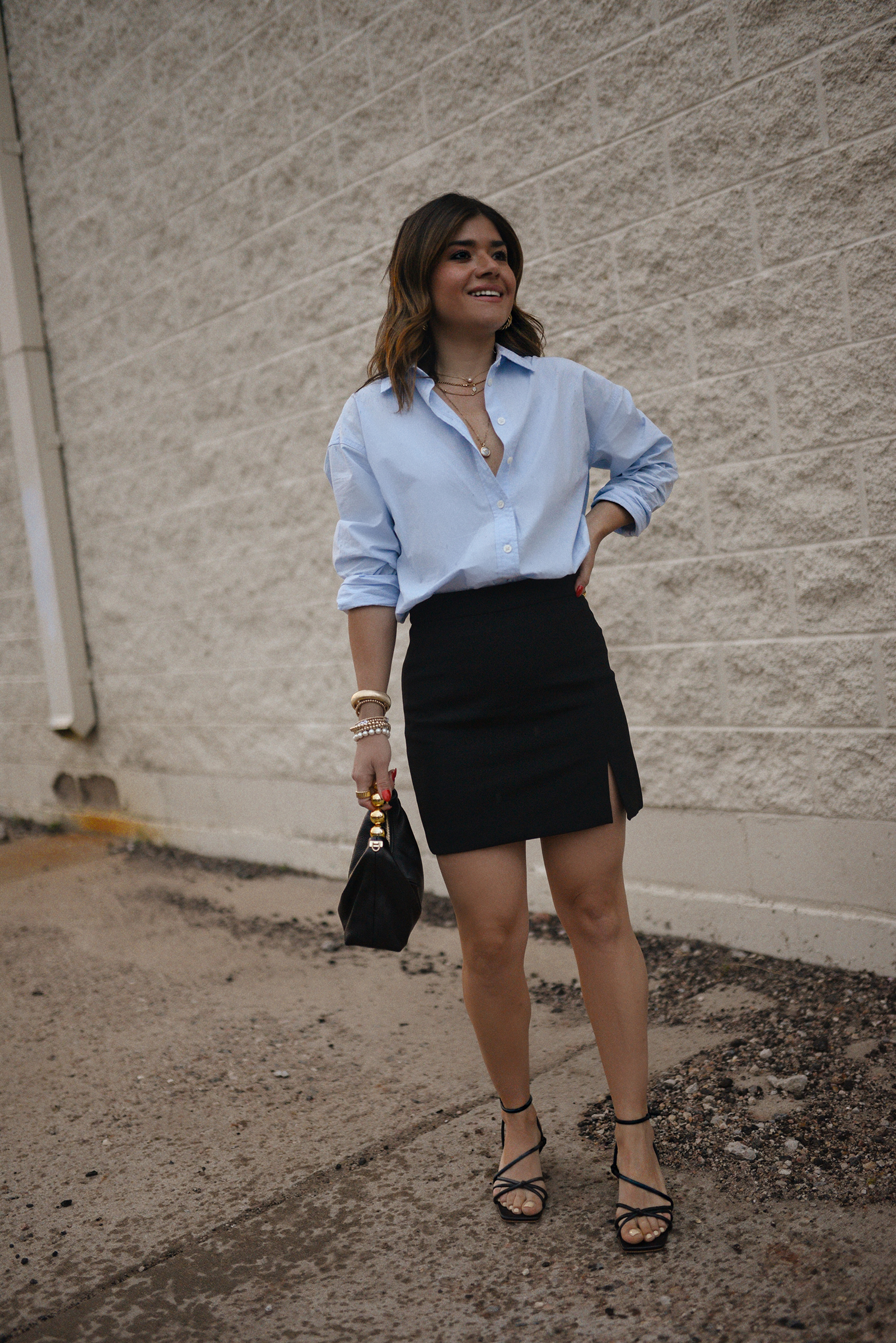 Carolina Hellal from Chic Talk wearing a Aritzia skirt, Target blue shirt, Dolce Vitta sandals and Jacquemus bag