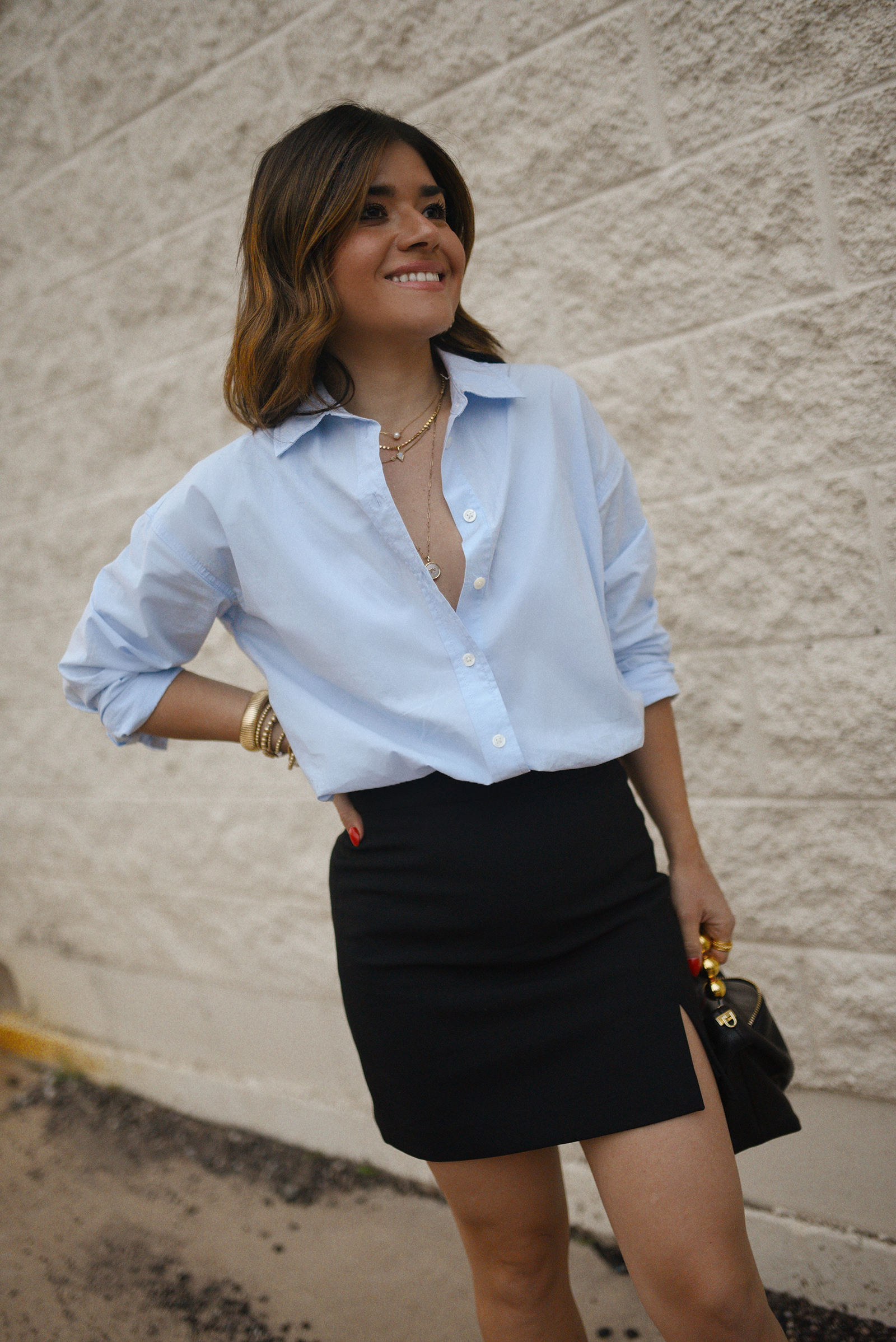 Carolina Hellal from Chic Talk wearing a Aritzia skirt, Target blue shirt, Dolce Vitta sandals and Jacquemus bag