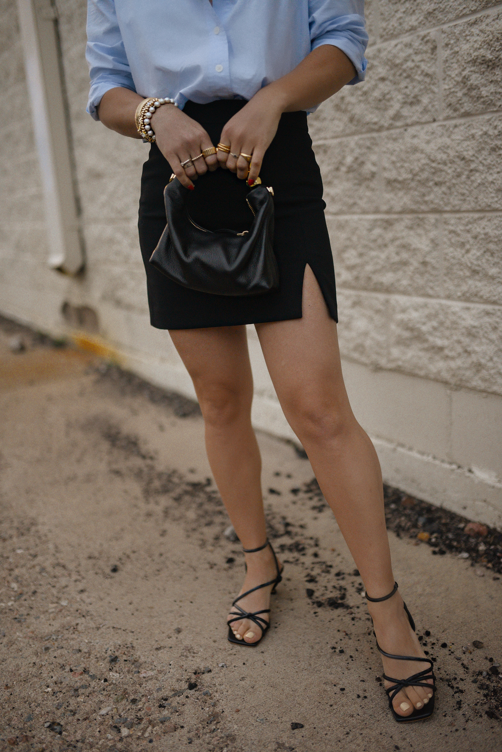 Carolina Hellal from Chic Talk wearing a Aritzia skirt, Target blue shirt, Dolce Vitta sandals and Jacquemus bag