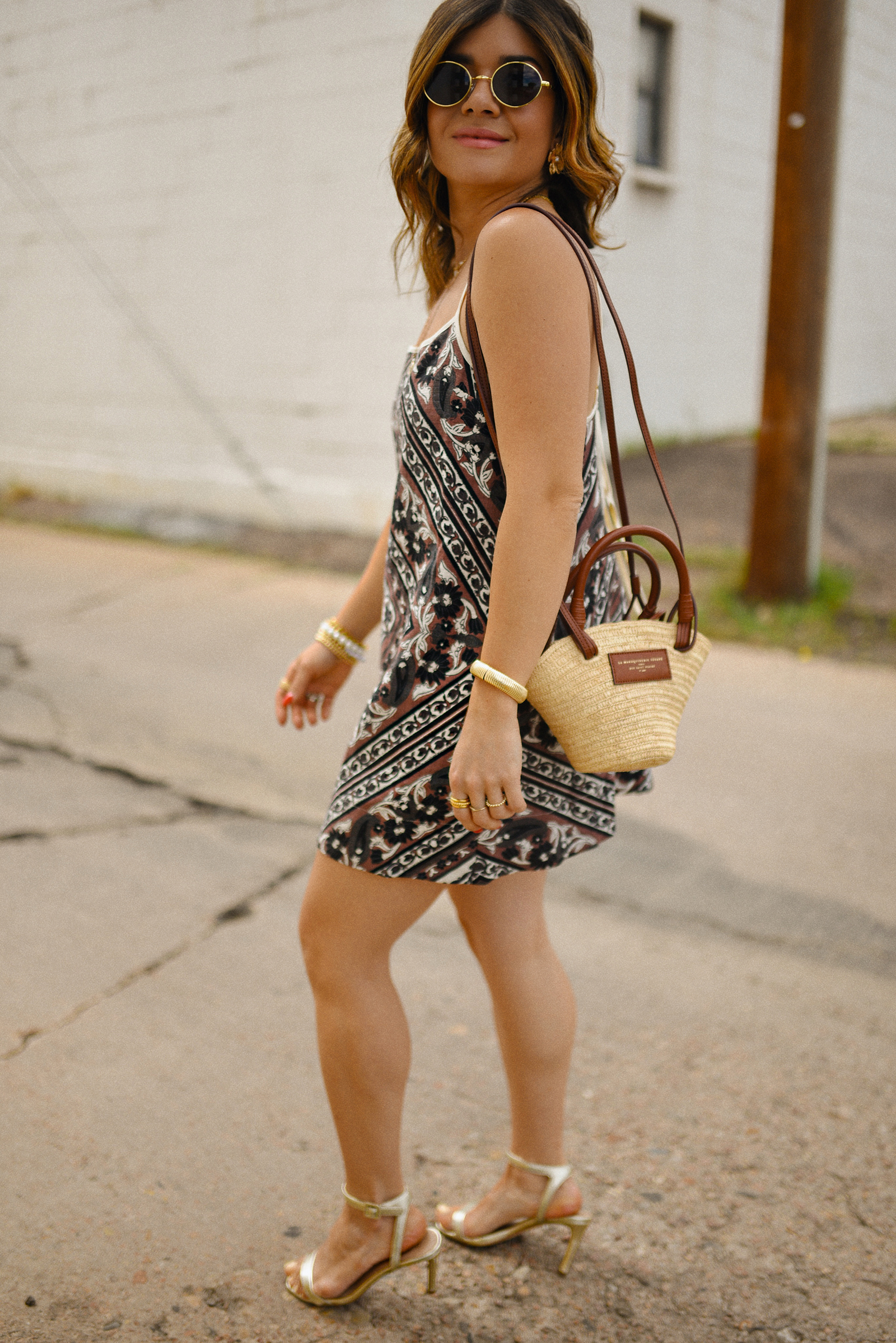 Carolina Hellal of Chic Talk wearin a Free People midi dress, Sézane rafia bag and Sam Edelman sandals