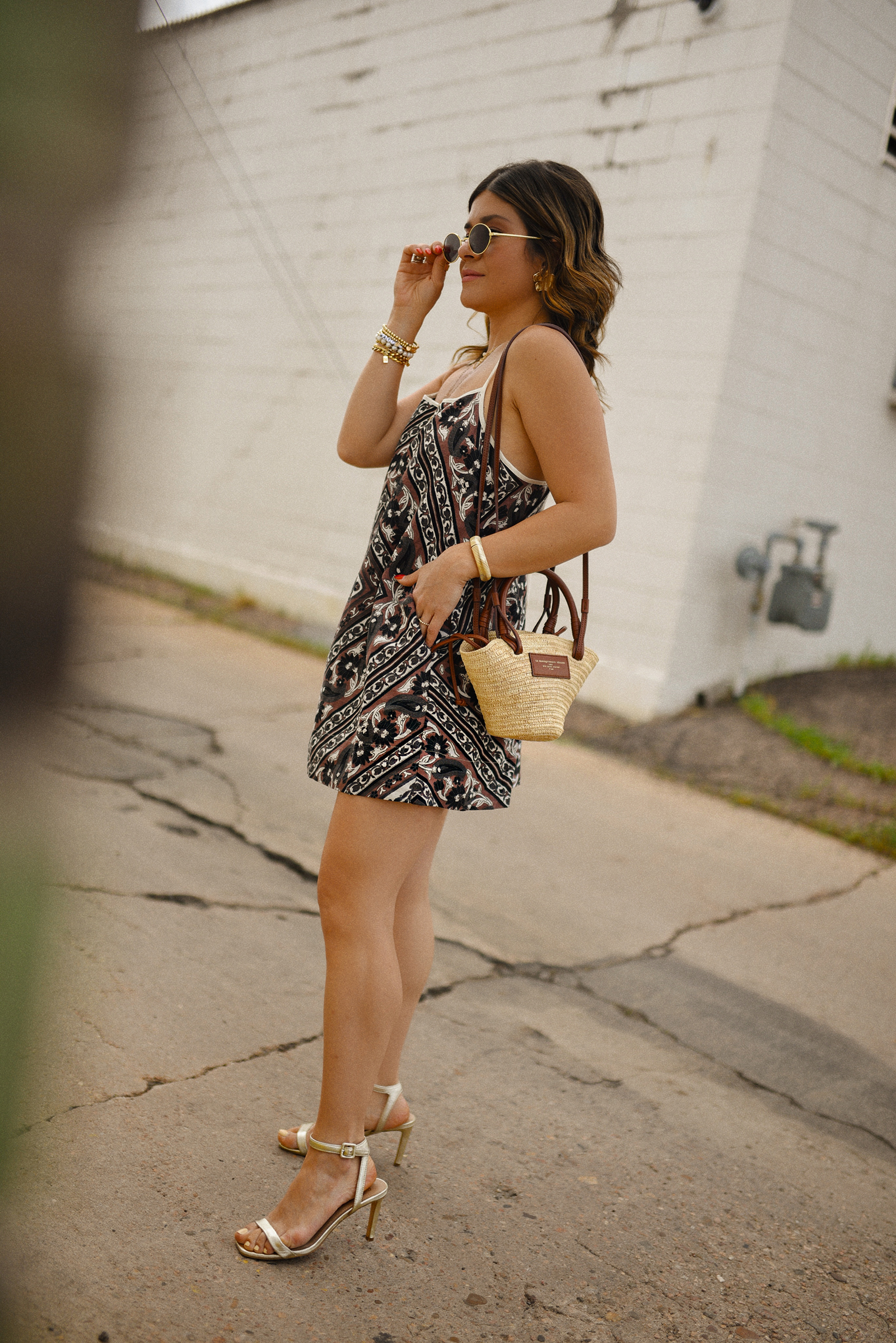 Carolina Hellal of Chic Talk wearin a Free People midi dress, Sézane rafia bag and Sam Edelman sandals