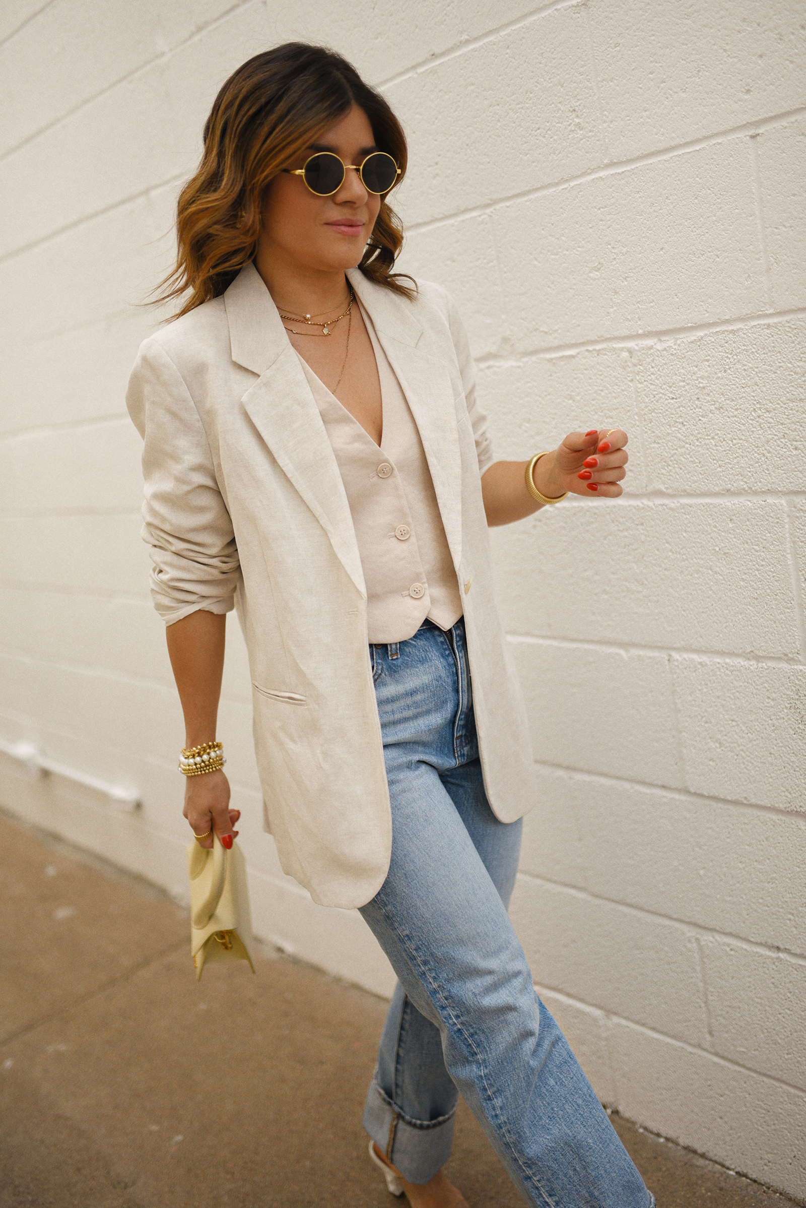 Carolina Hellal of Chic Talk wearing a Madewell jeans and vest, H&M blazer, Jacquemus hand bag and transparent sandals