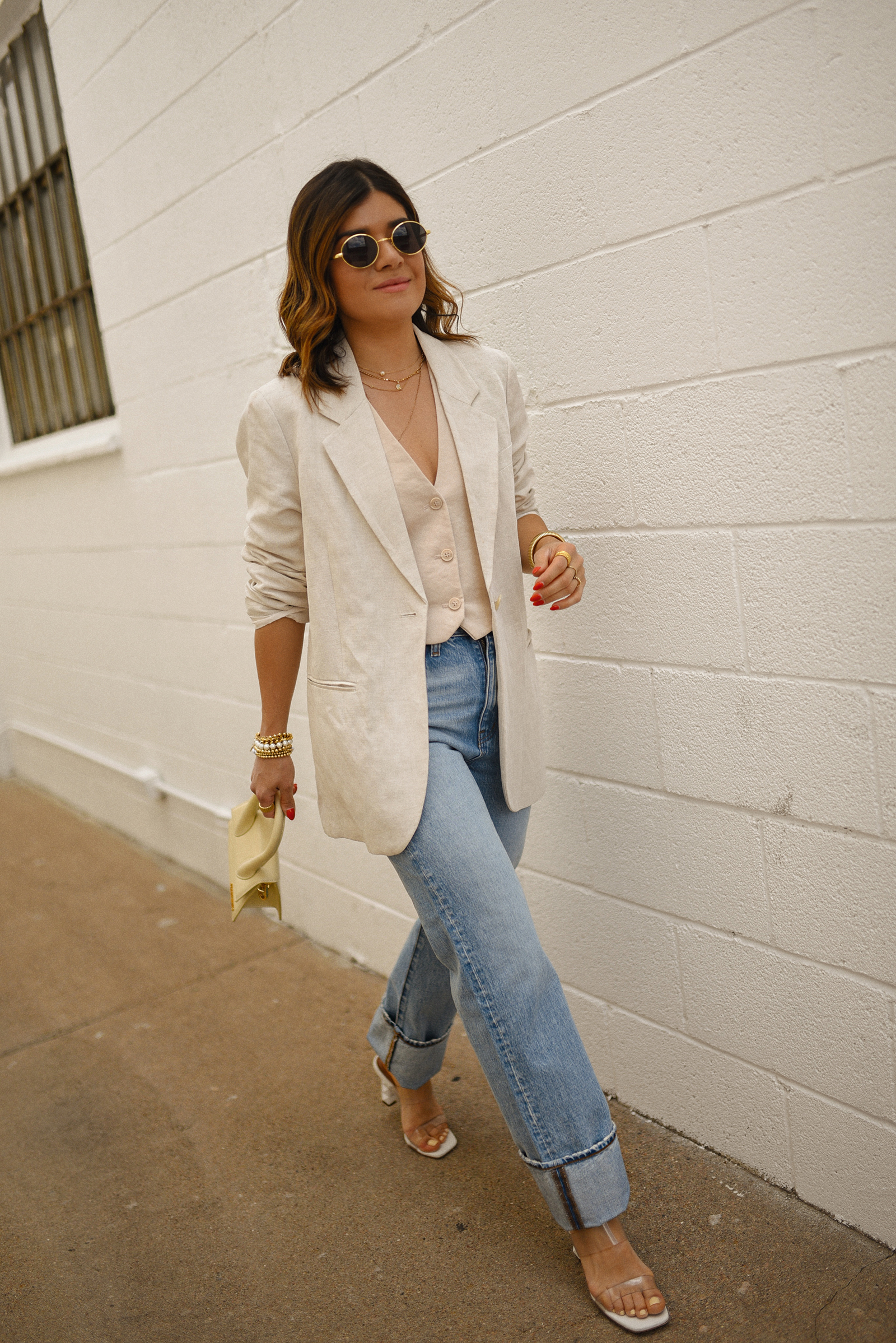 Carolina Hellal of Chic Talk wearing a Madewell jeans and vest, H&M blazer, Jacquemus hand bag and transparent sandals