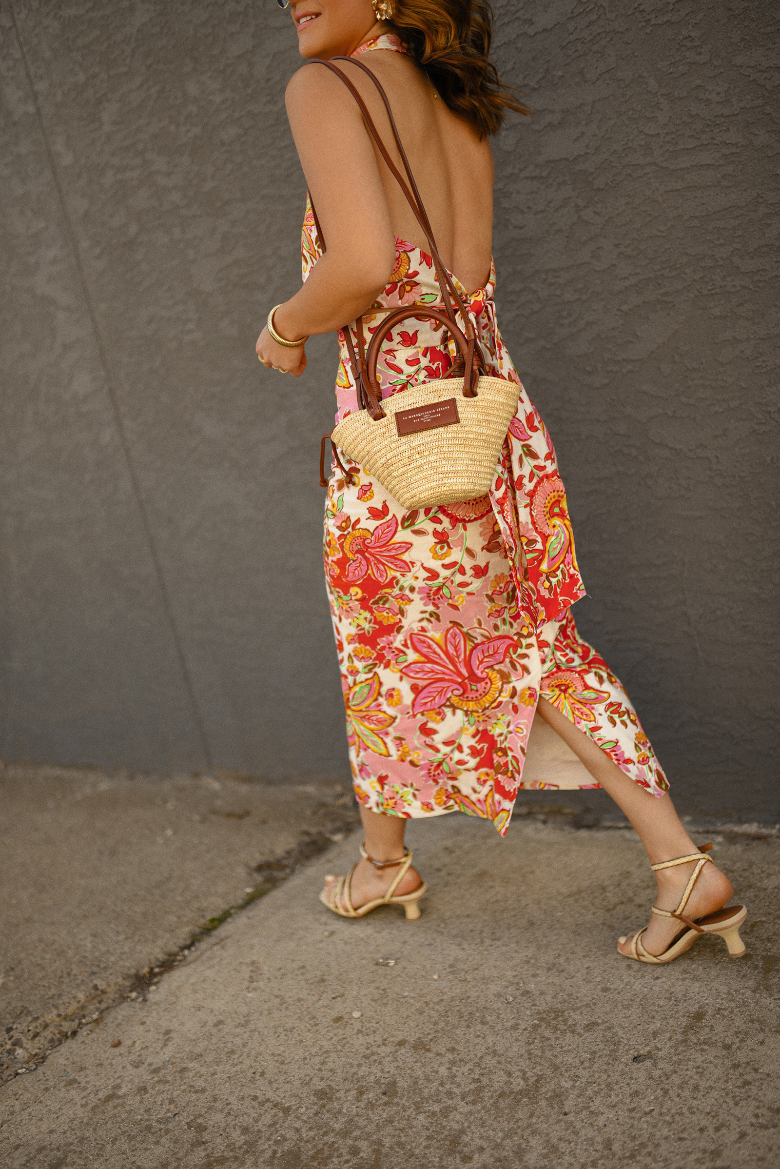 Carolina Hellal of Chic Talk wearing a Sezane floral set of top and midi skirt, a rafia bag, a Target sandals and Amazon sunglasses