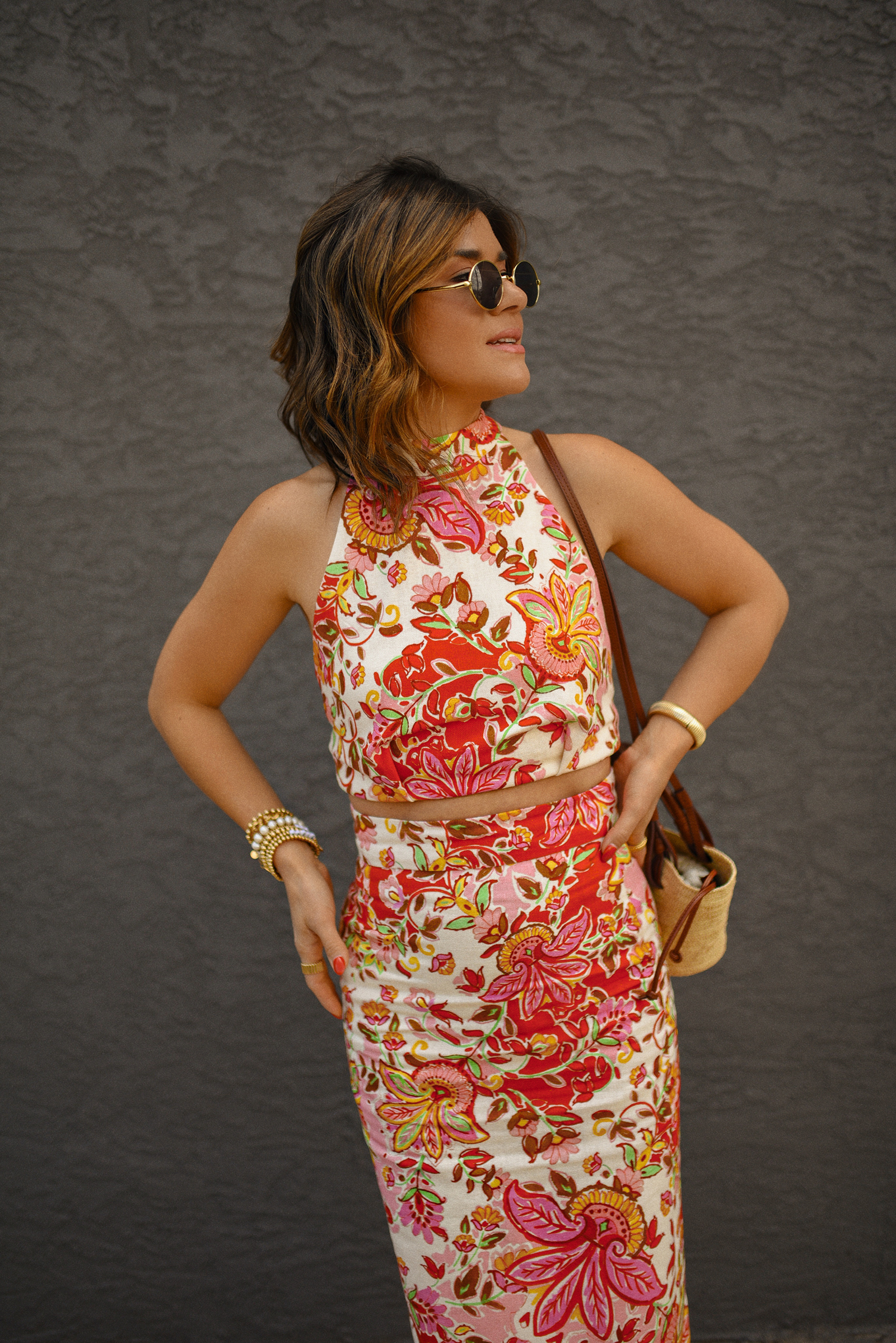 Carolina Hellal of Chic Talk wearing a Sezane floral set of top and midi skirt, a rafia bag, a Target sandals and Amazon sunglasses