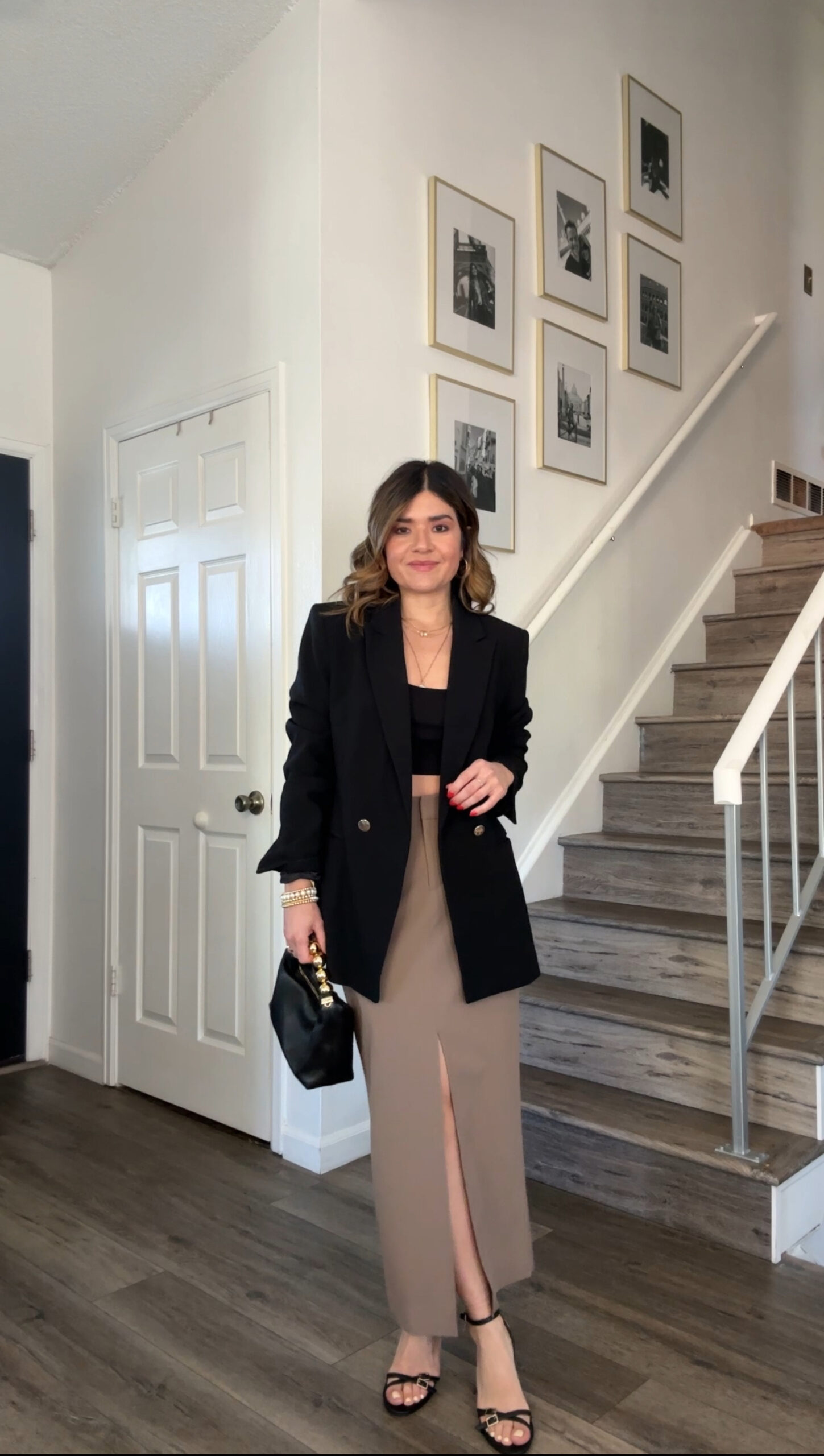 Carolina Hellal of Chic Talk wearing a nude midi skirt, and black blazer and top via Nordstrom. And black sandals and handbag.