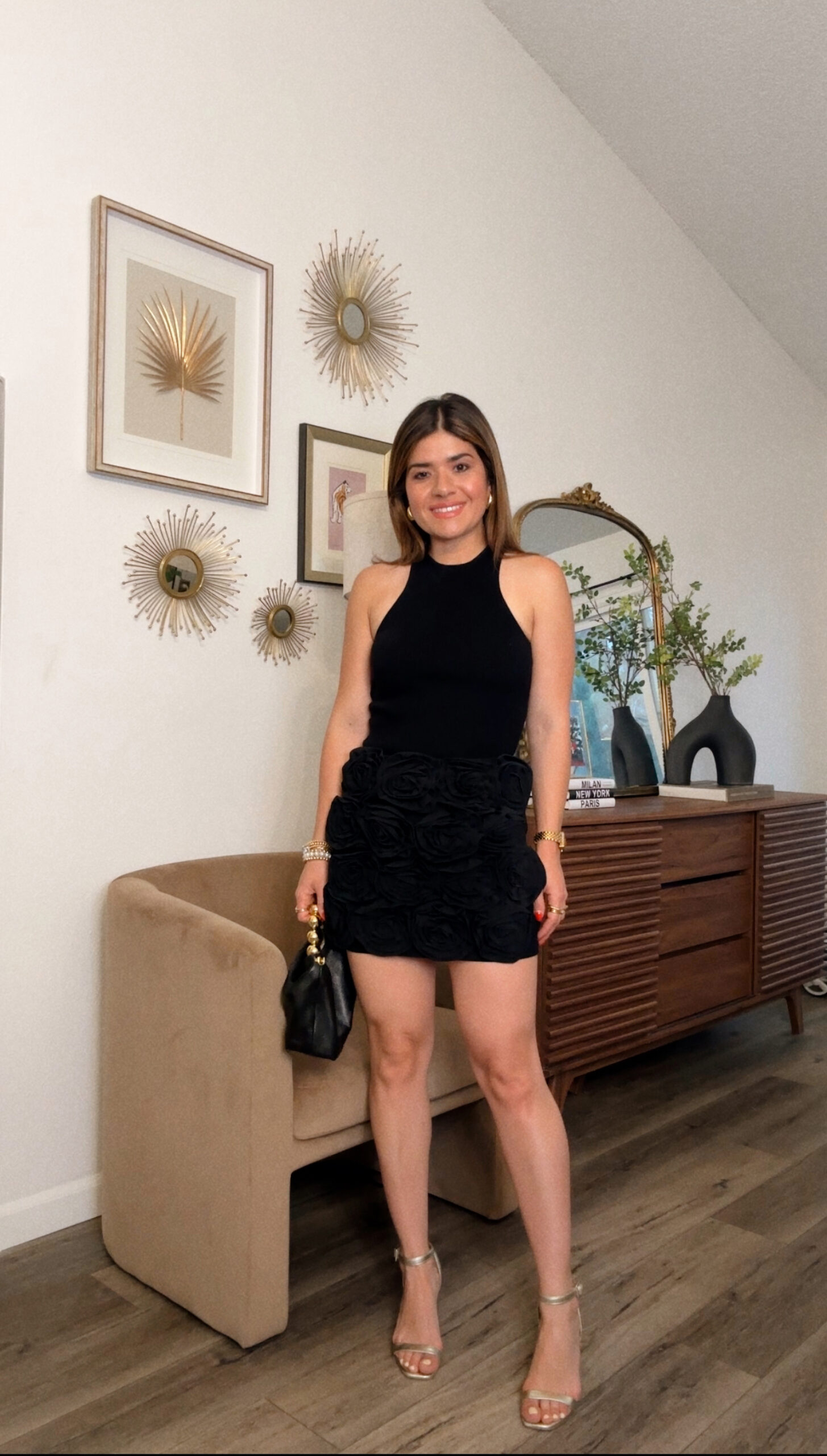 Carolina Hellal of Chic Talk wearing a AFRM top and skirt, gold sandals and a black handbag via Amazon