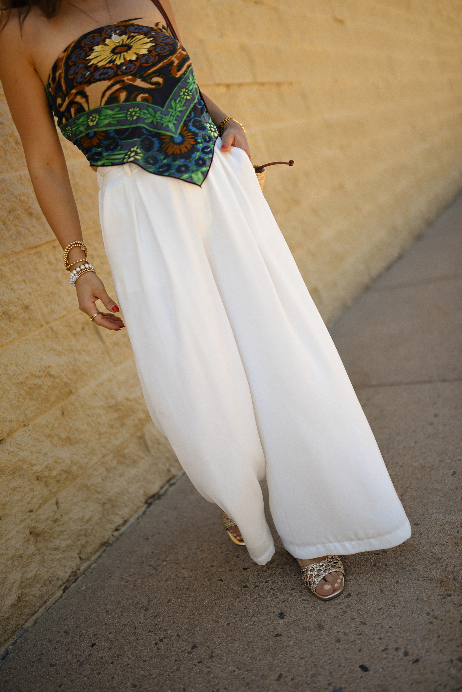 Carolina Hellal of Chic Talk wearing a Bandana top via Free people, trousers pants, Sezane rafia bag and Boden Sandals