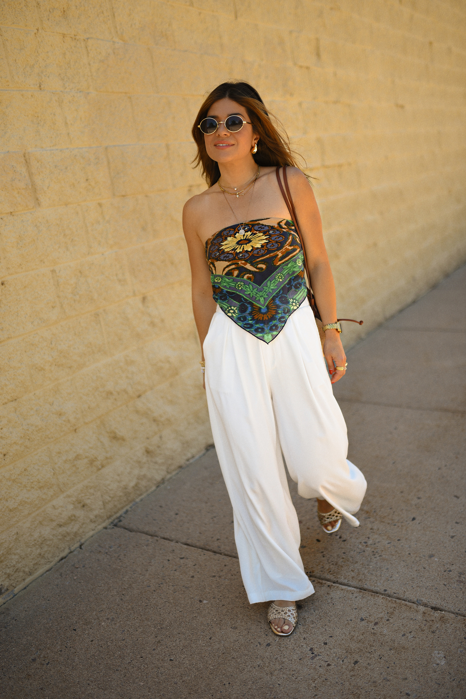 Carolina Hellal of Chic Talk wearing a Bandana top via Free people, trousers pants, Sezane rafia bag and Boden Sandals