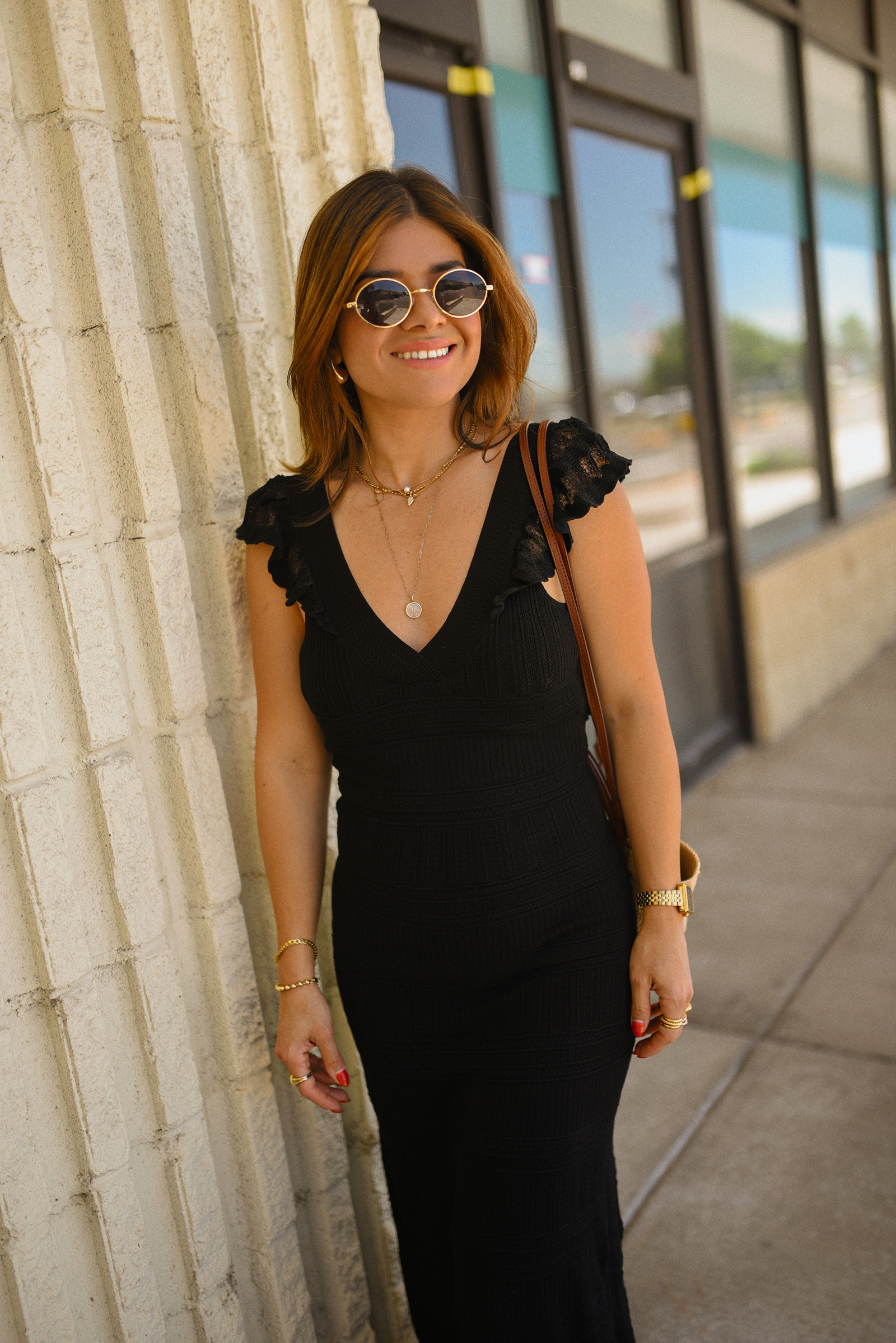 Carolina Hellal of Chic Talk wearing a black midi dress and rafia bag via Sezane