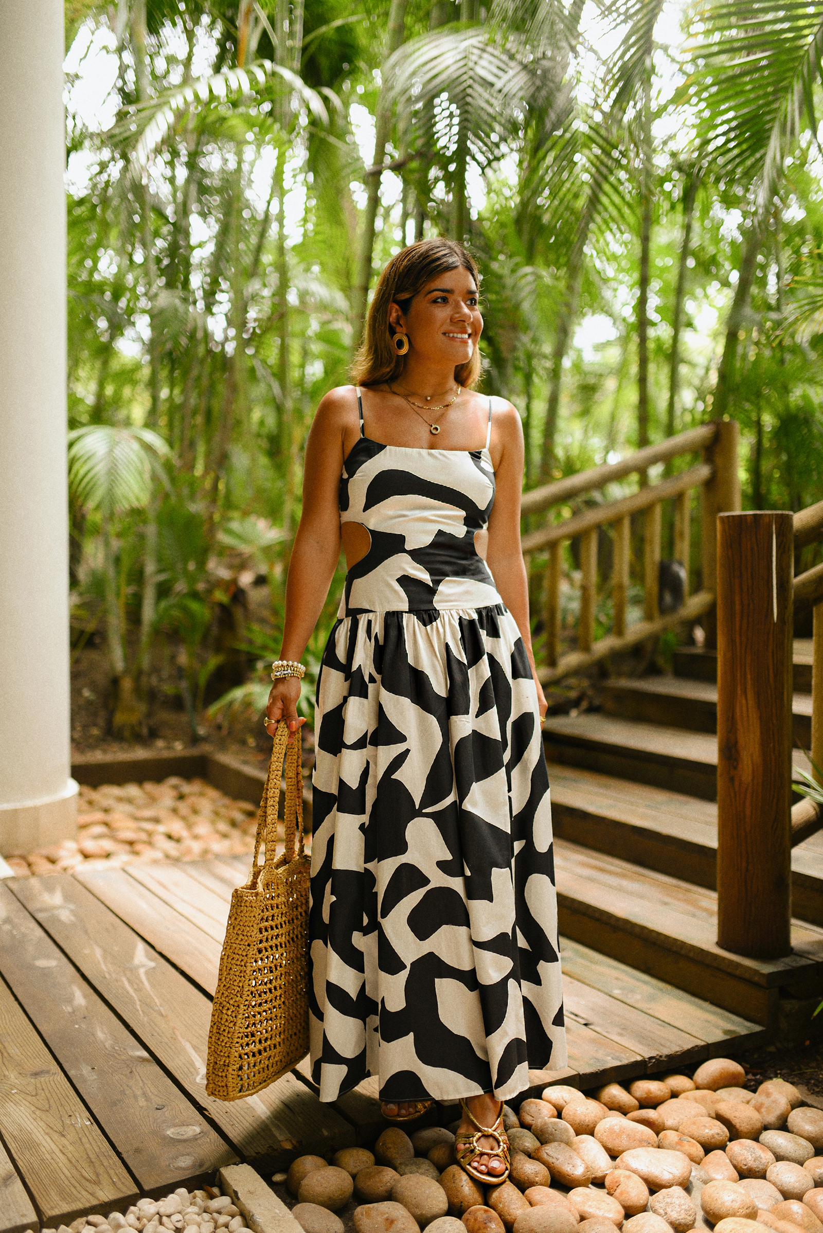 Carolina Hellal of Chic Talk wearing a Abercrombie midi dress, Aritzia raffia bag and Sezane sandals