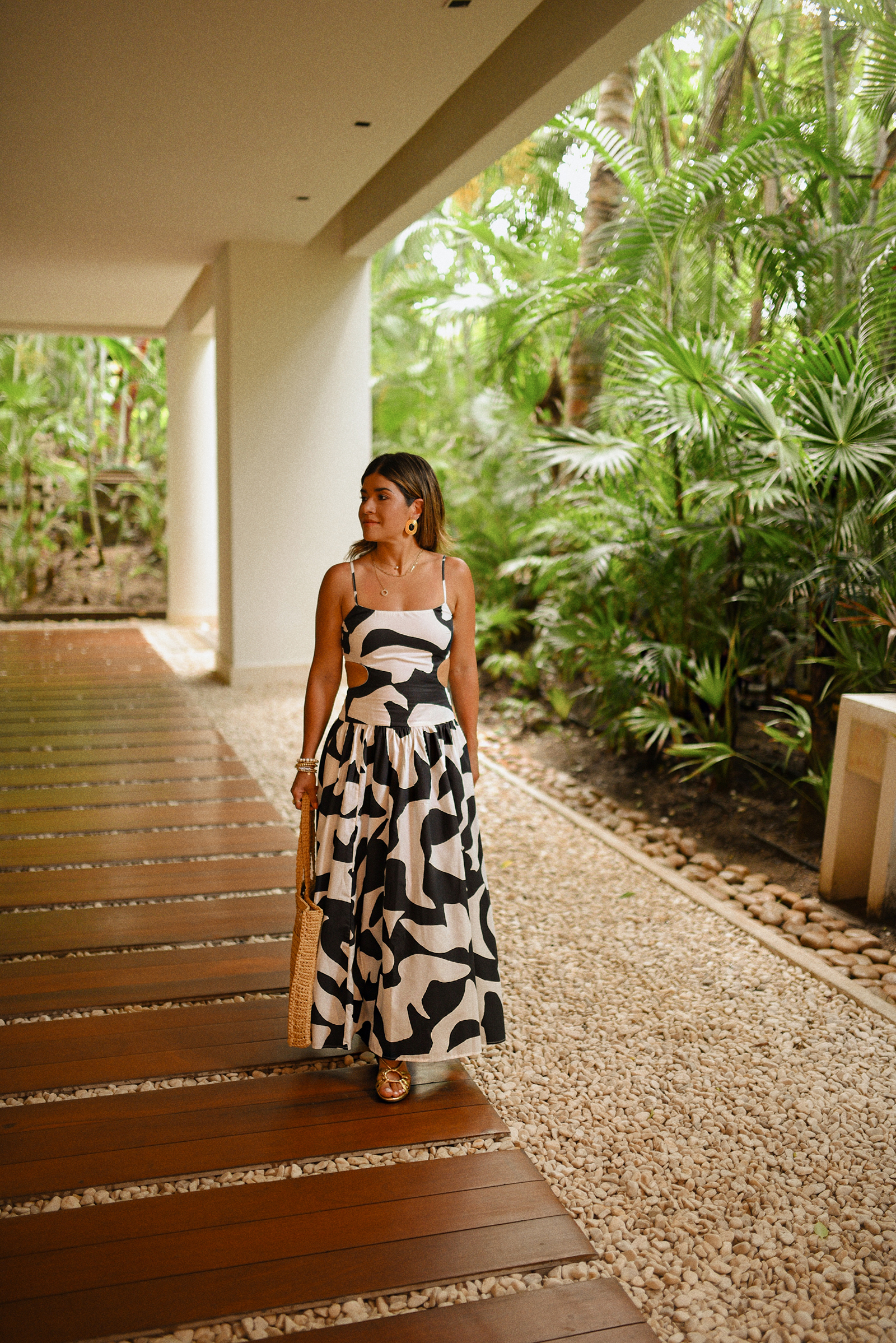 Carolina Hellal of Chic Talk wearing a Abercrombie midi dress, Aritzia raffia bag and Sezane sandals