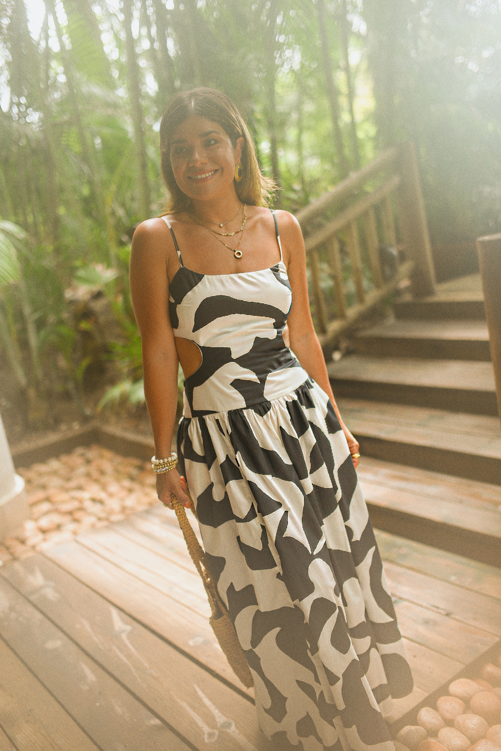 Carolina Hellal of Chic Talk wearing a Abercrombie midi dress, Aritzia raffia bag and Sezane sandals