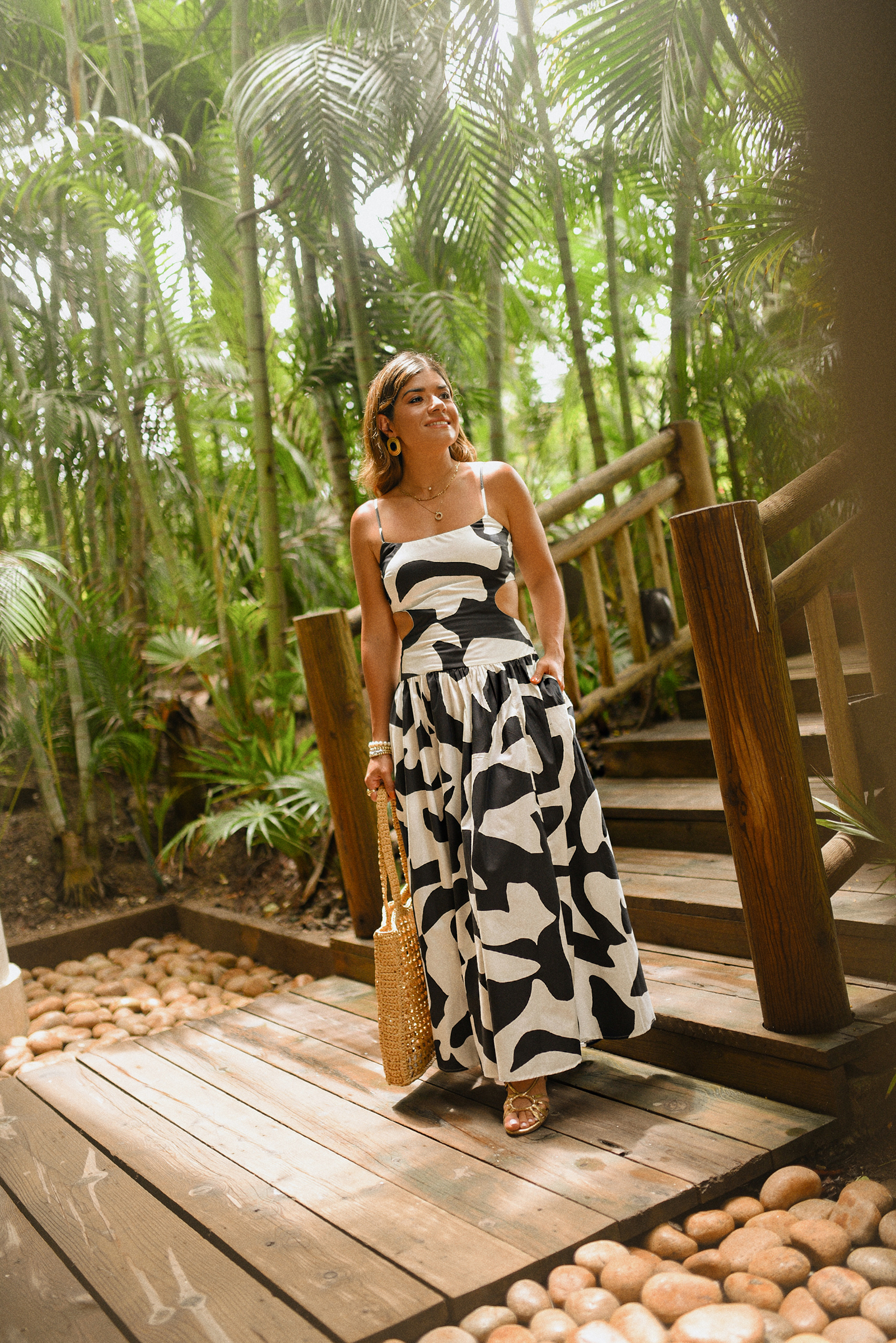 Carolina Hellal of Chic Talk wearing a Abercrombie midi dress, Aritzia raffia bag and Sezane sandals