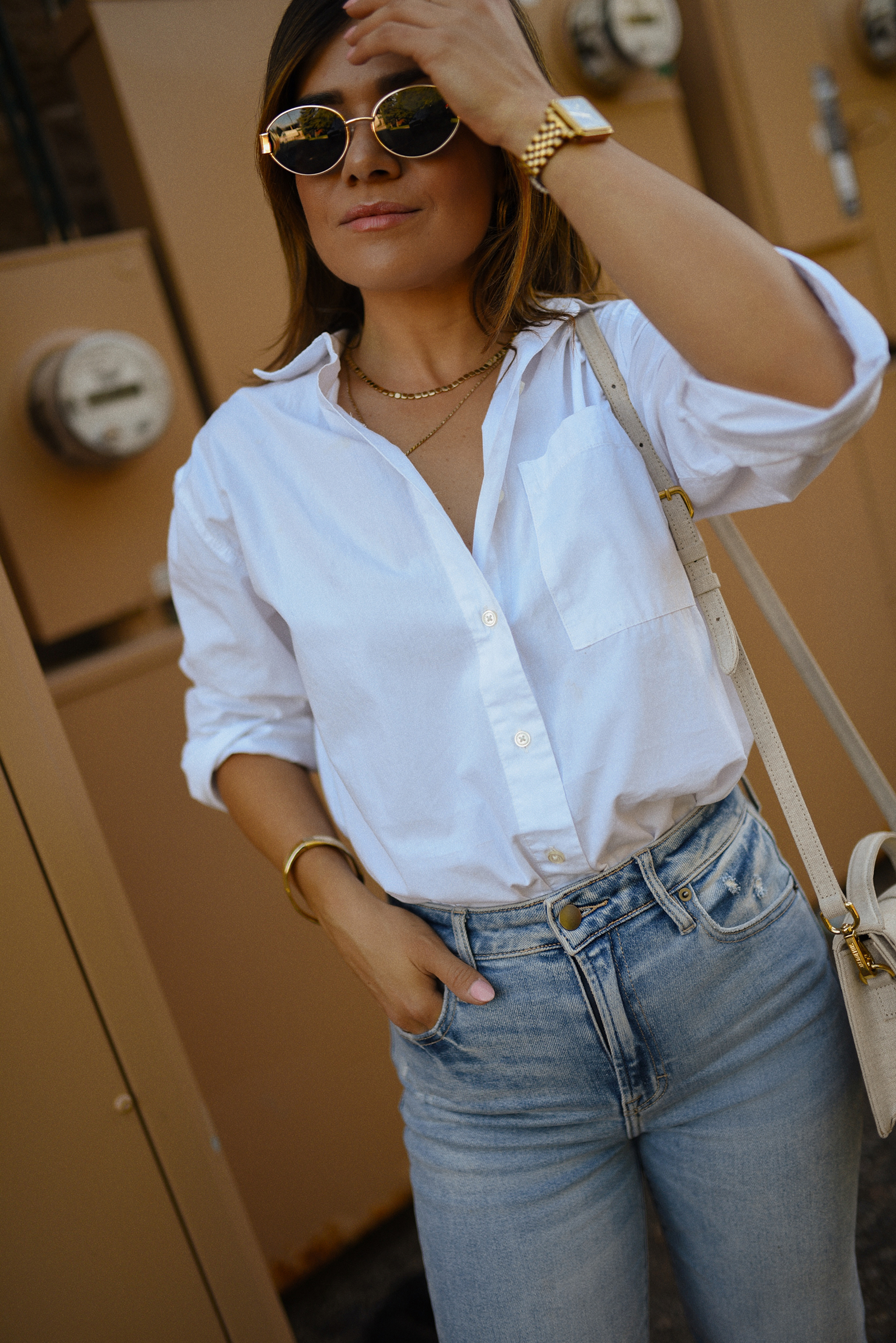 Carolina Hellal of Chic Talk wearing a Dolce Vita suede pumps, Vici jeans, Walmart white shirt and Jacquemus beige bag