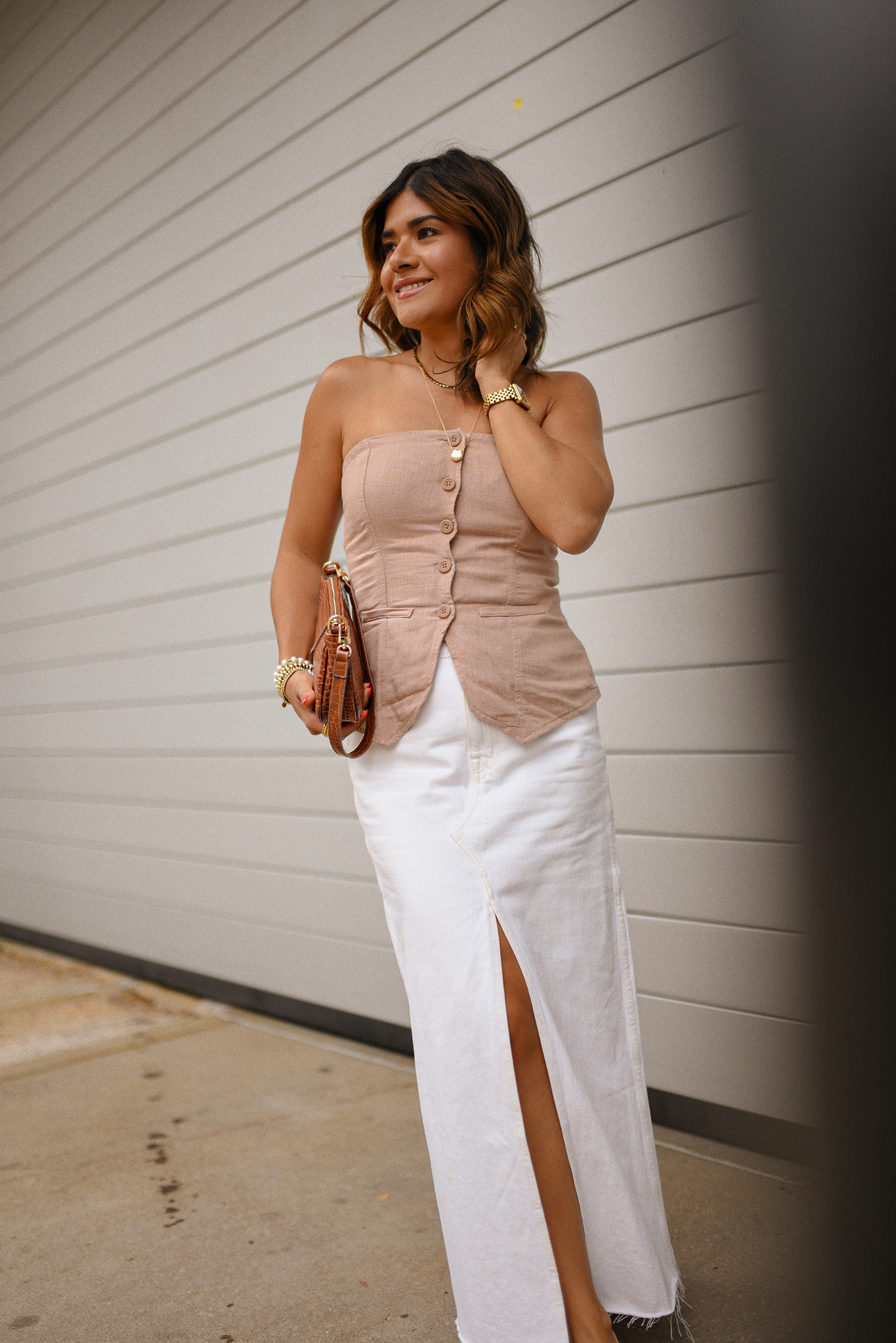 Carolina Hellal of Chic Talk wearing a Madewell white midi skirt, Target suiting tube top, Amazon handbag, and Sam Edelman Mary Jane shoes