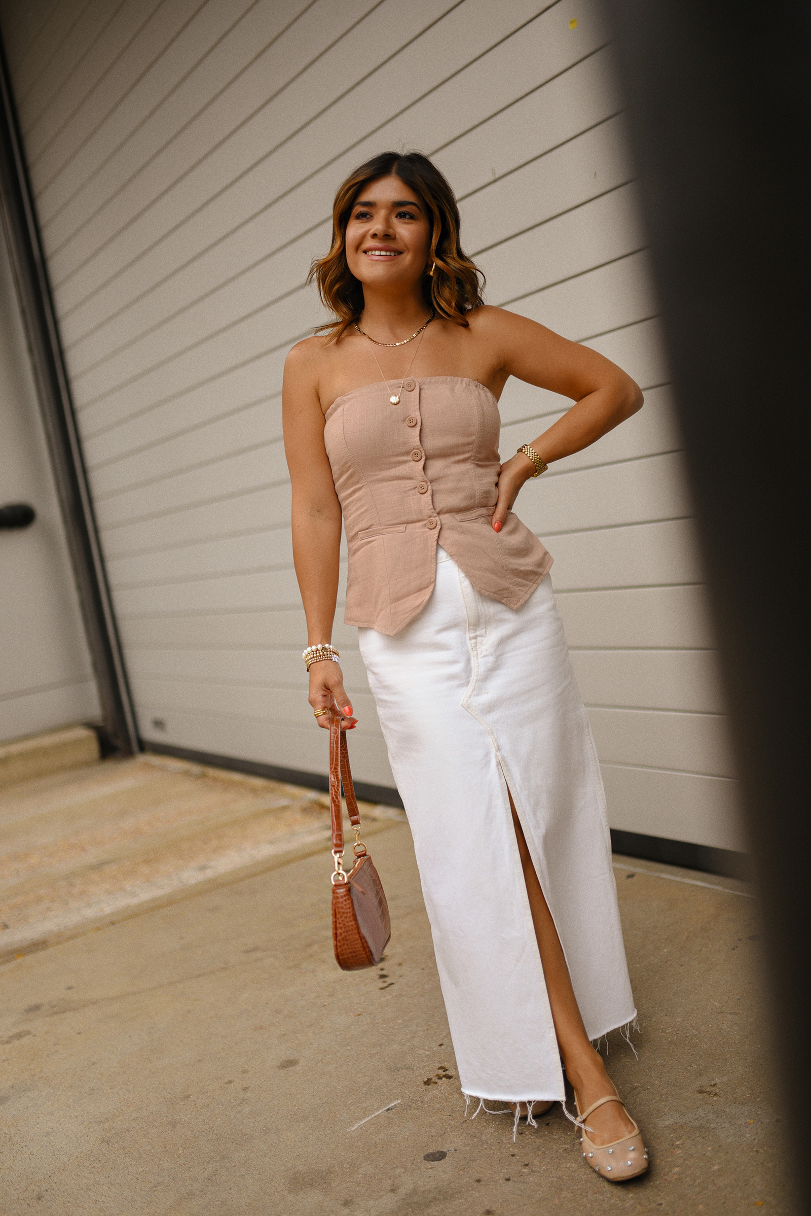 Carolina Hellal of Chic Talk wearing a Madewell white midi skirt, Target suiting tube top, Amazon handbag, and Sam Edelman Mary Jane shoes