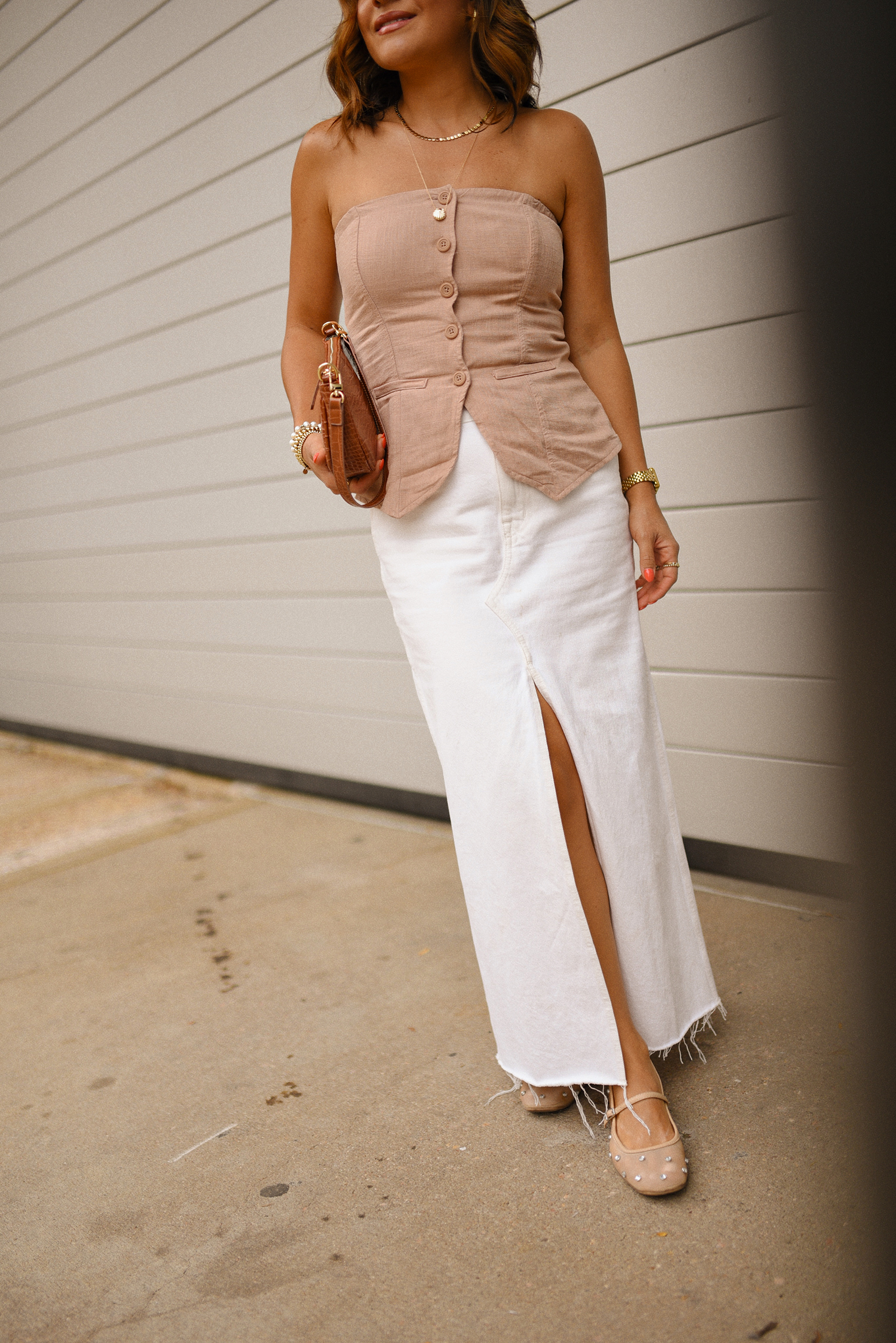 Carolina Hellal of Chic Talk wearing a Madewell white midi skirt, Target suiting tube top, Amazon handbag, and Sam Edelman Mary Jane shoes