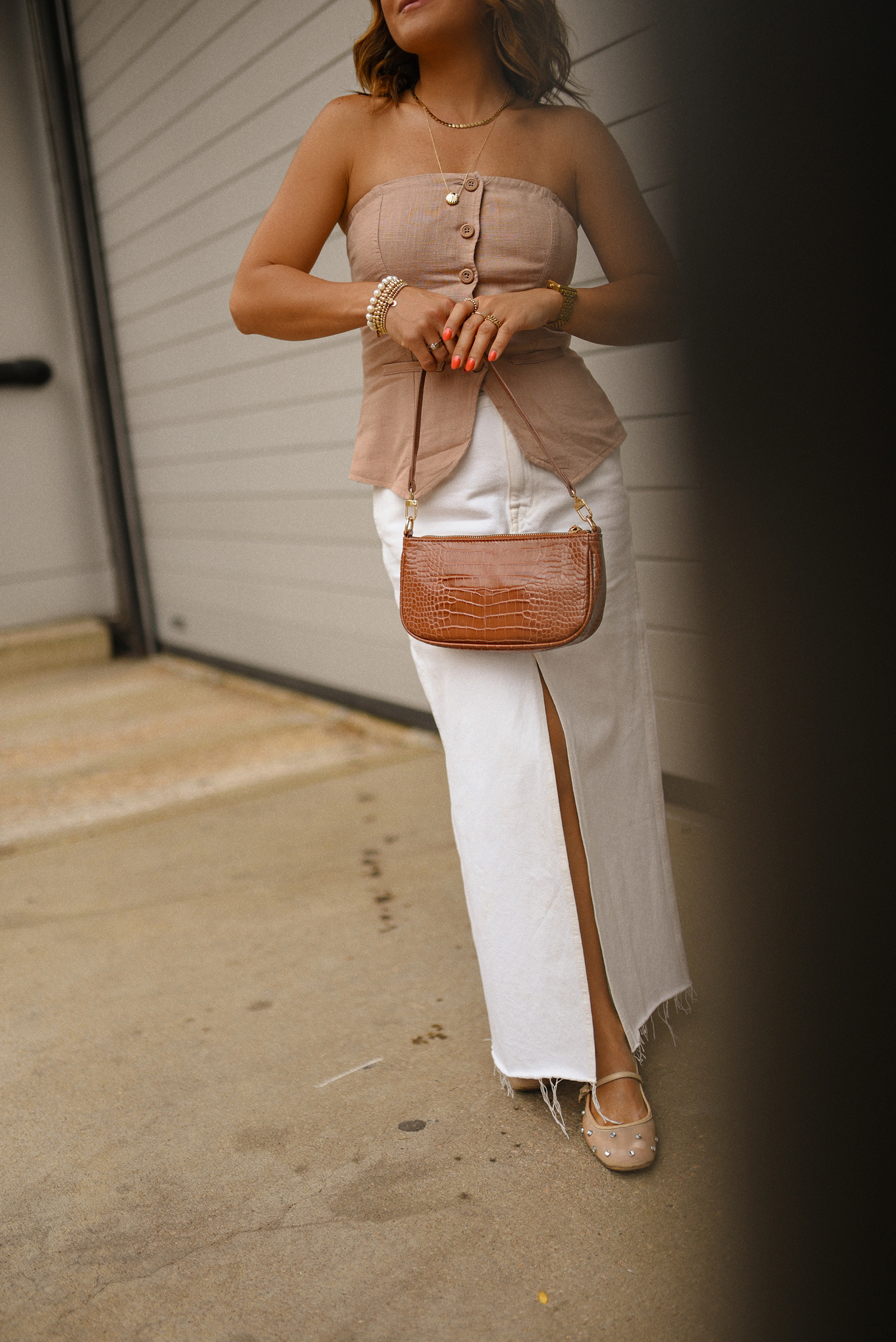 Carolina Hellal of Chic Talk wearing a Madewell white midi skirt, Target suiting tube top, Amazon handbag, and Sam Edelman Mary Jane shoes