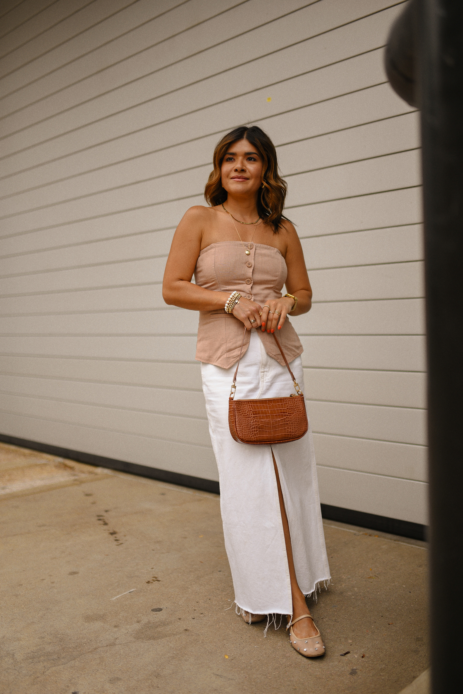 Carolina Hellal of Chic Talk wearing a Madewell white midi skirt, Target suiting tube top, Amazon handbag, and Sam Edelman Mary Jane shoes