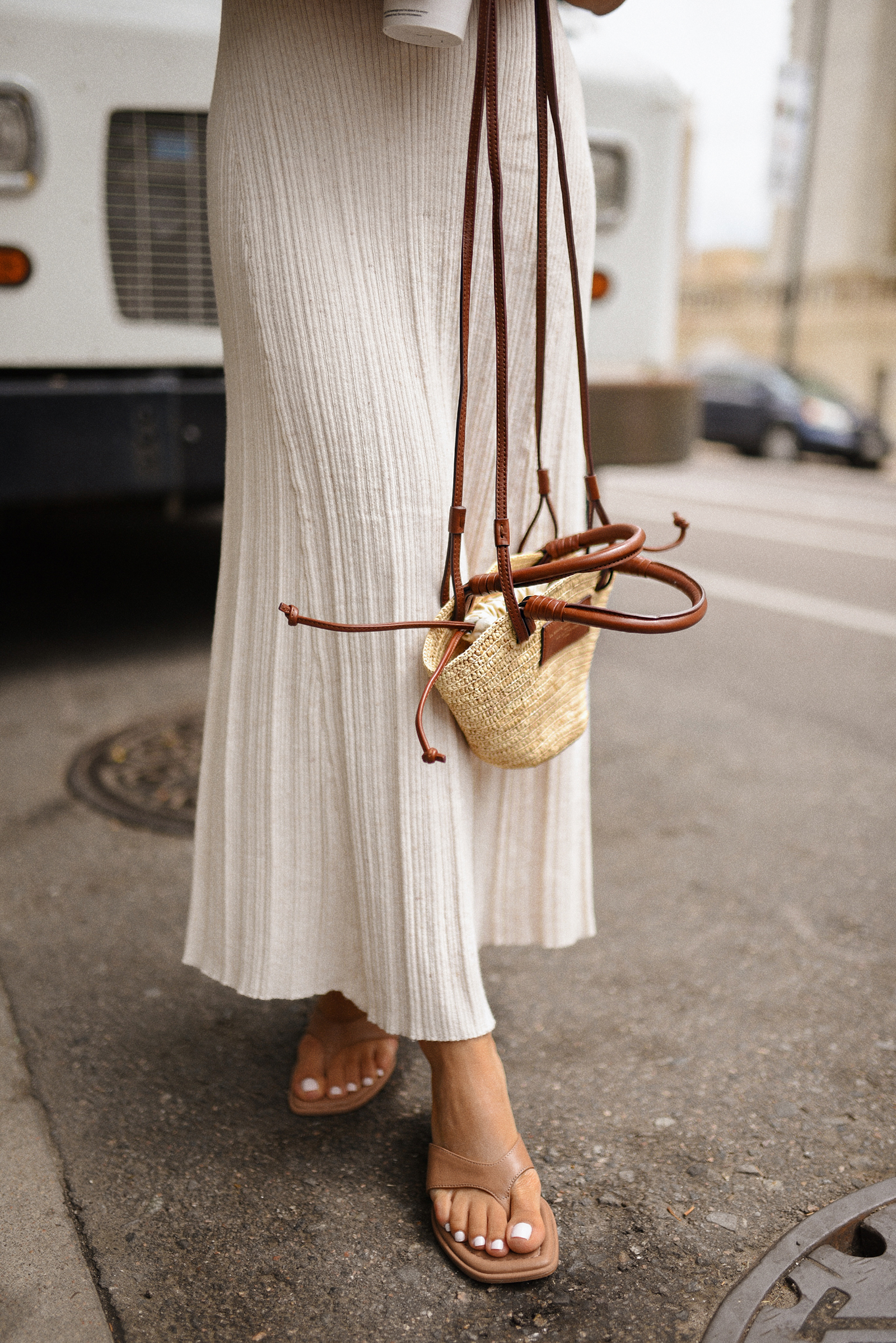 Carolina Hellal of Chic Talk wearing a Target dress and sandals and Sezane handbag