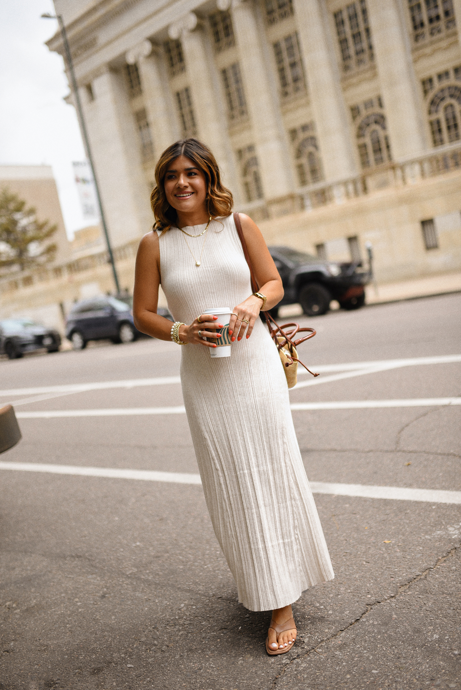 Carolina Hellal of Chic Talk wearing a Target dress and sandals and Sezane handbag