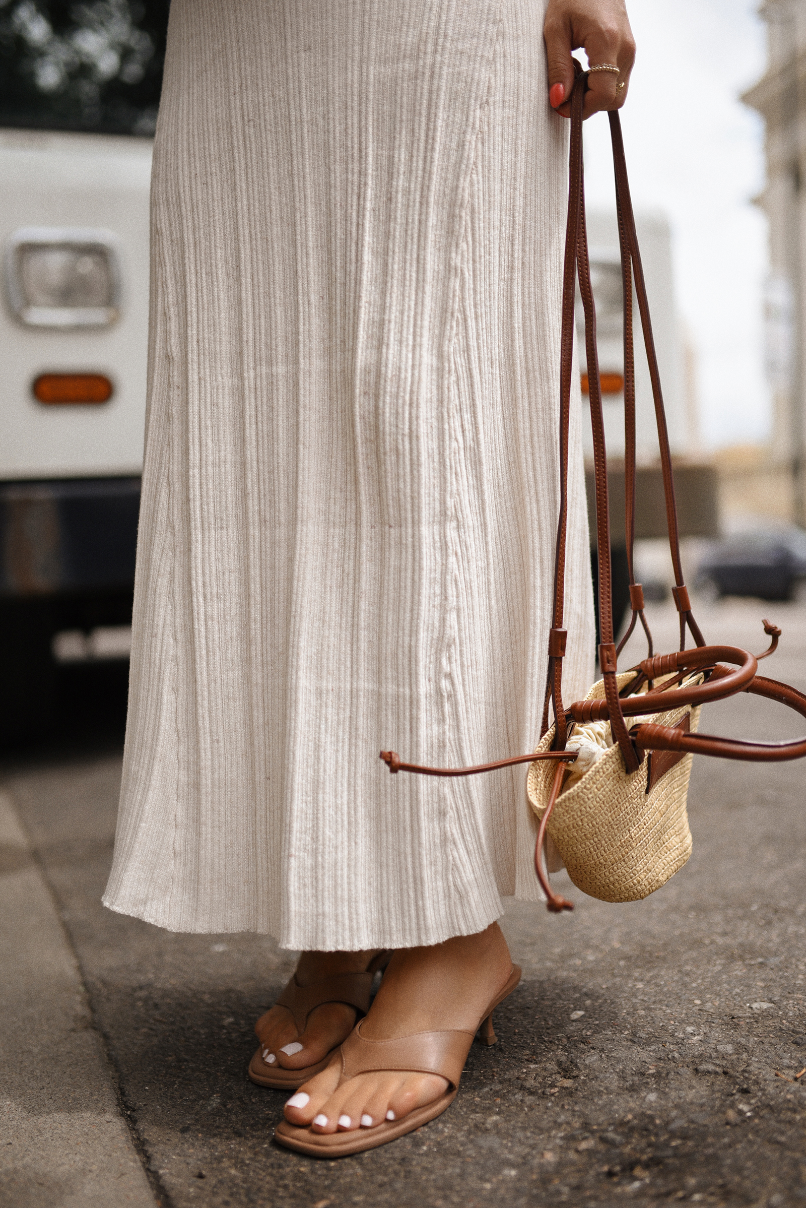 Carolina Hellal of Chic Talk wearing a Target dress and sandals and Sezane handbag