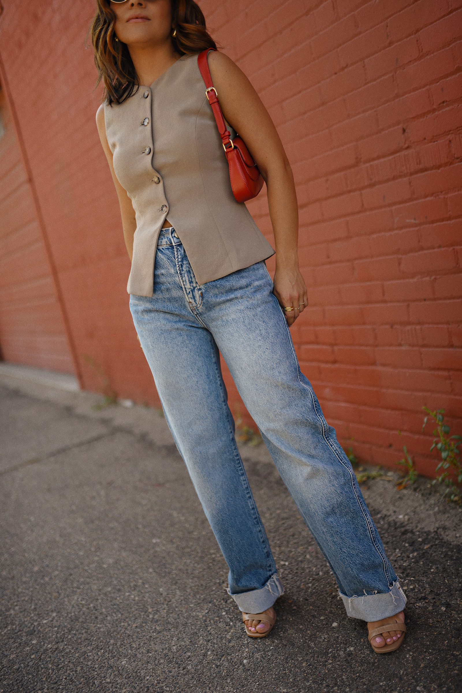 Carolina Hellal of Chic Talk wearing a Aritzia vest and blazer, Reformation wide leg jeans and Anrthropologie hand bag