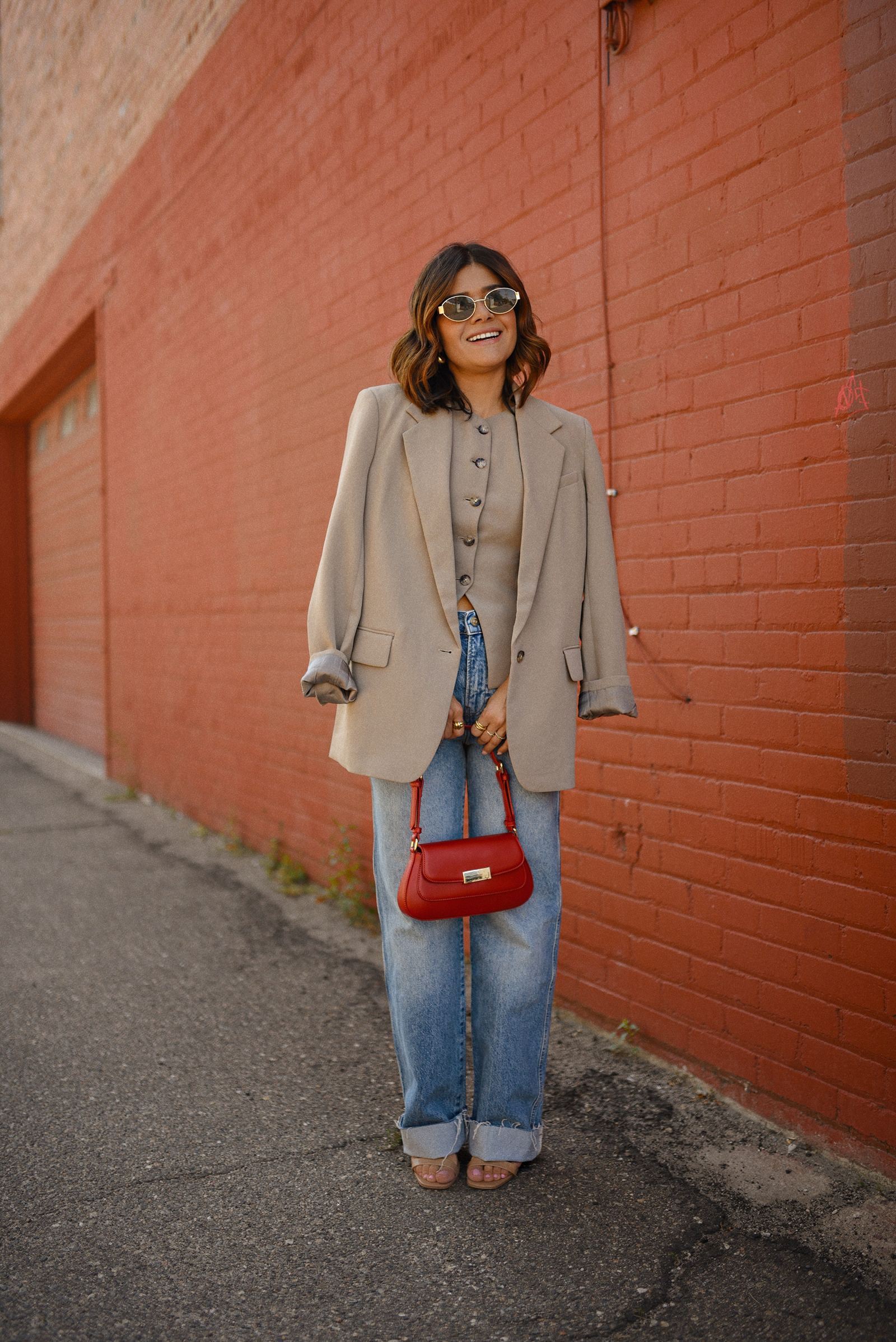 Carolina Hellal of Chic Talk wearing a Aritzia vest and blazer, Reformation wide leg jeans and Anrthropologie hand bag