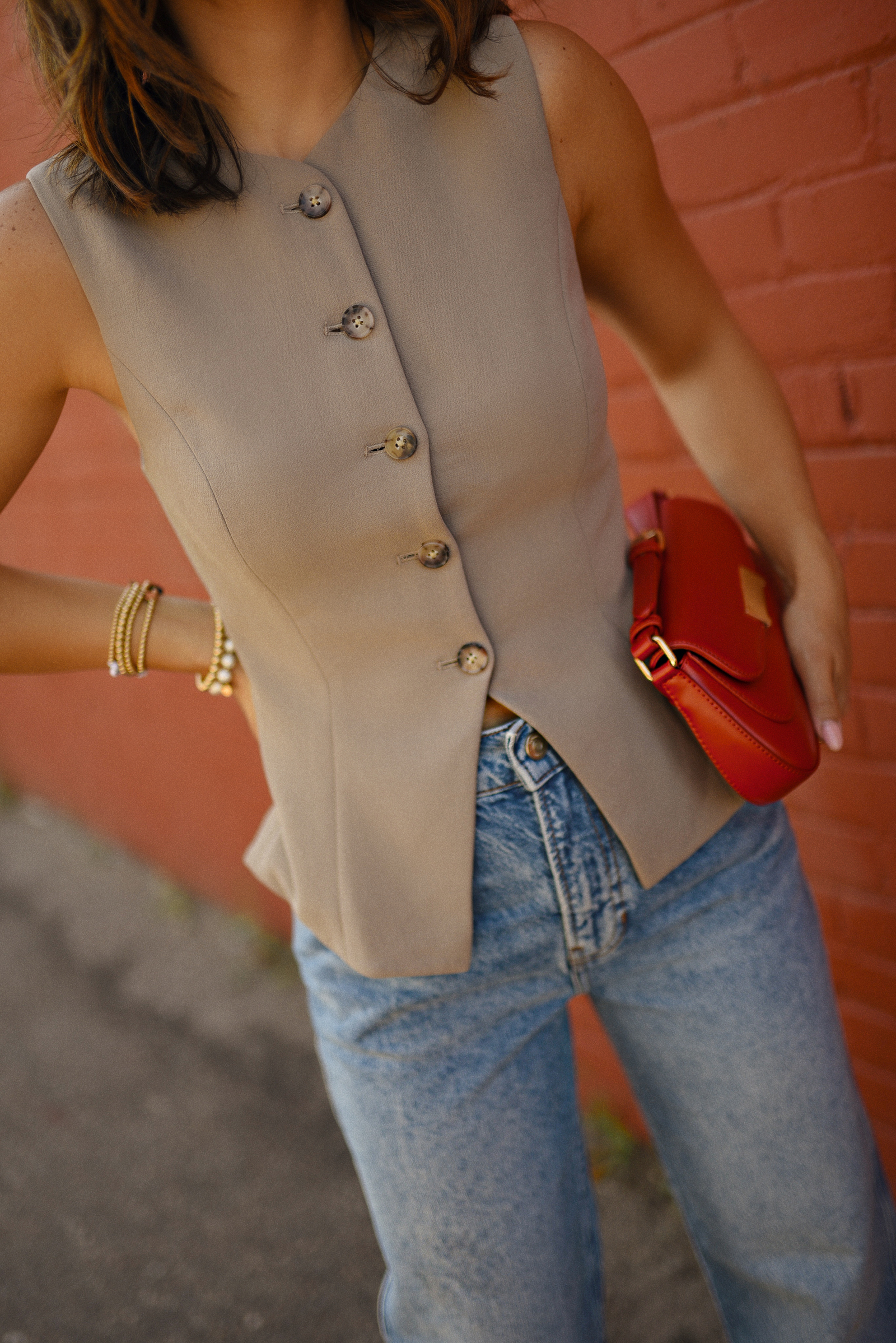 Carolina Hellal of Chic Talk wearing a Aritzia vest and blazer, Reformation wide leg jeans and Anrthropologie hand bag