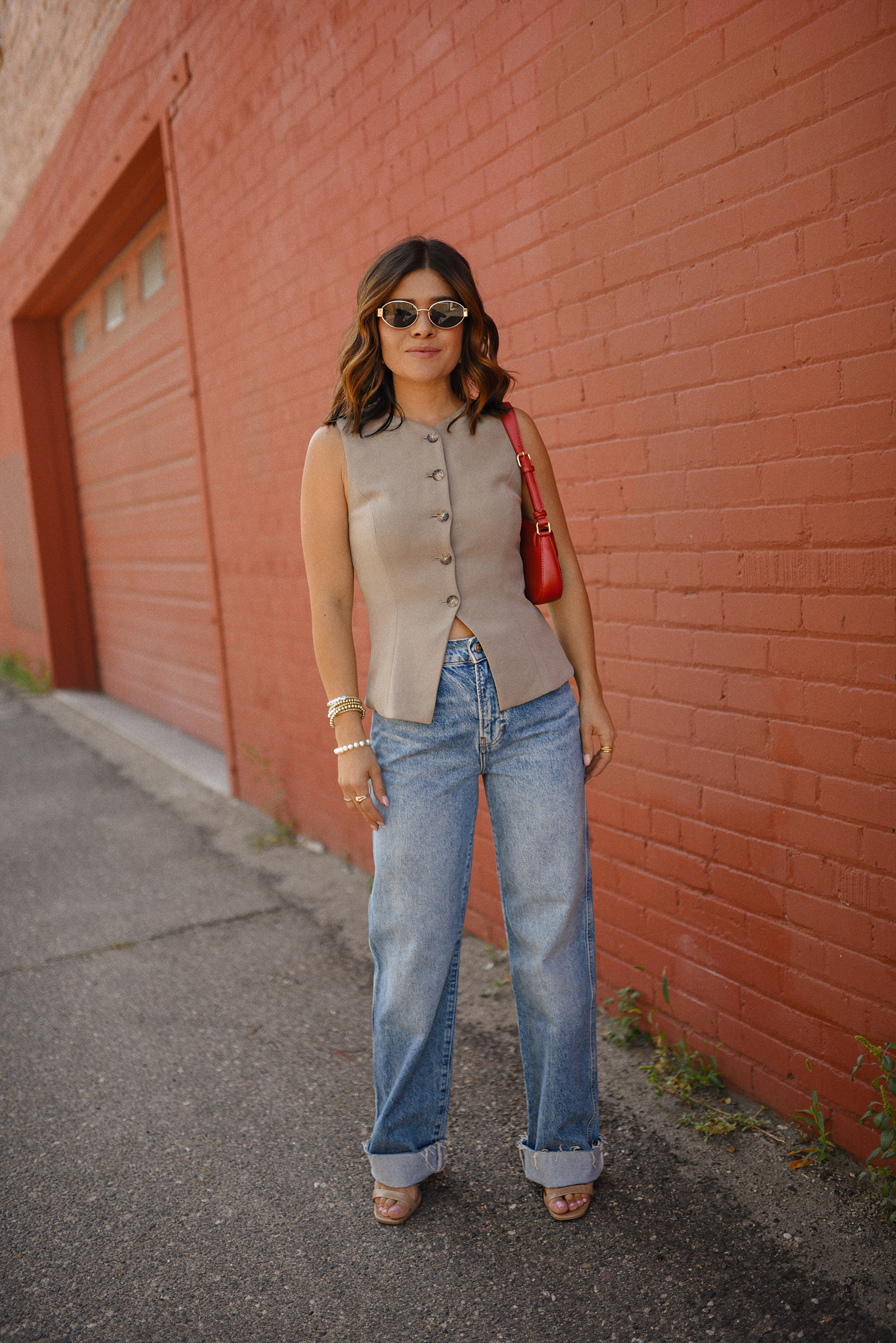 Carolina Hellal of Chic Talk wearing a Aritzia vest and blazer, Reformation wide leg jeans and Anrthropologie hand bag