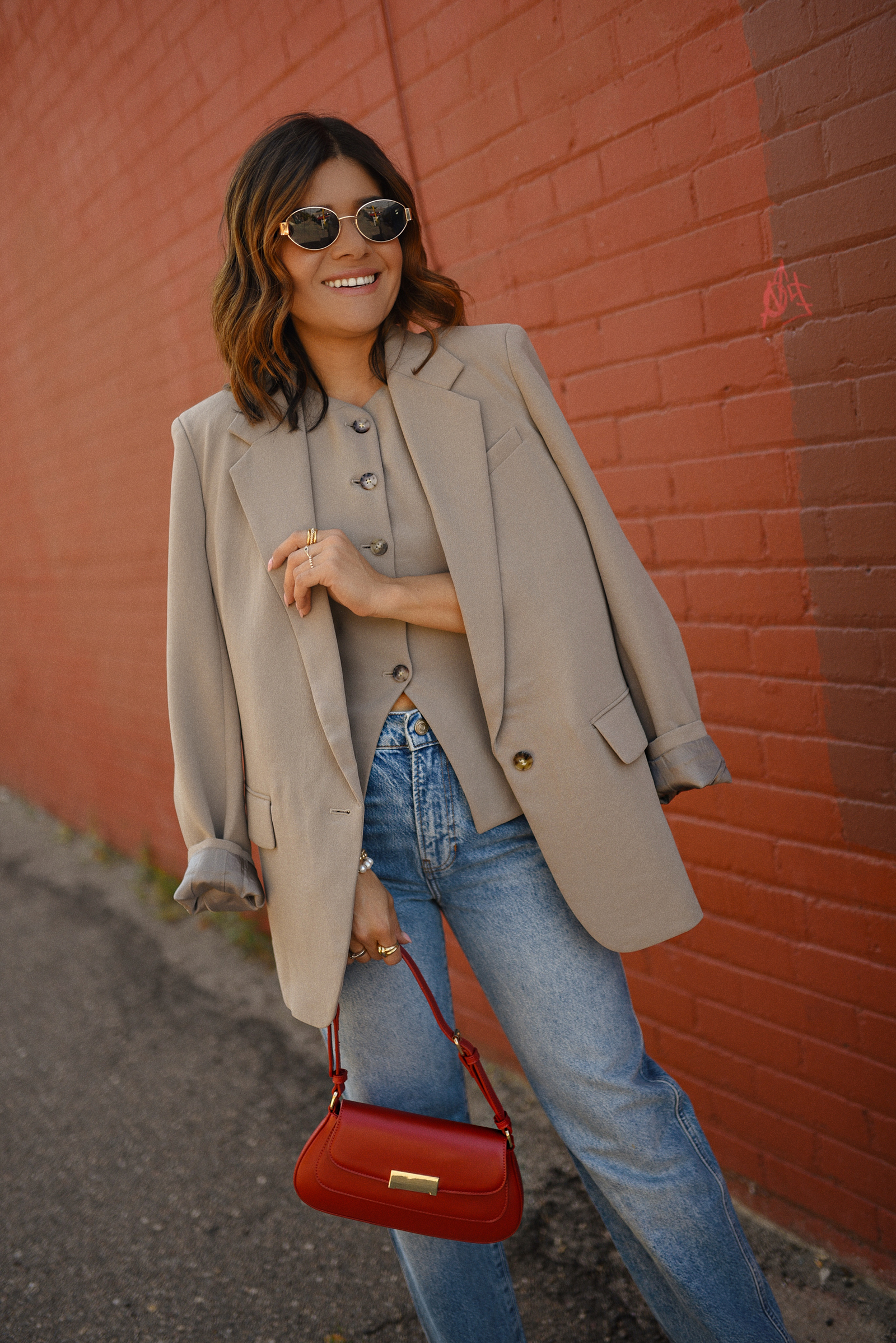 Carolina Hellal of Chic Talk wearing a Aritzia vest and blazer, Reformation wide leg jeans and Anrthropologie hand bag