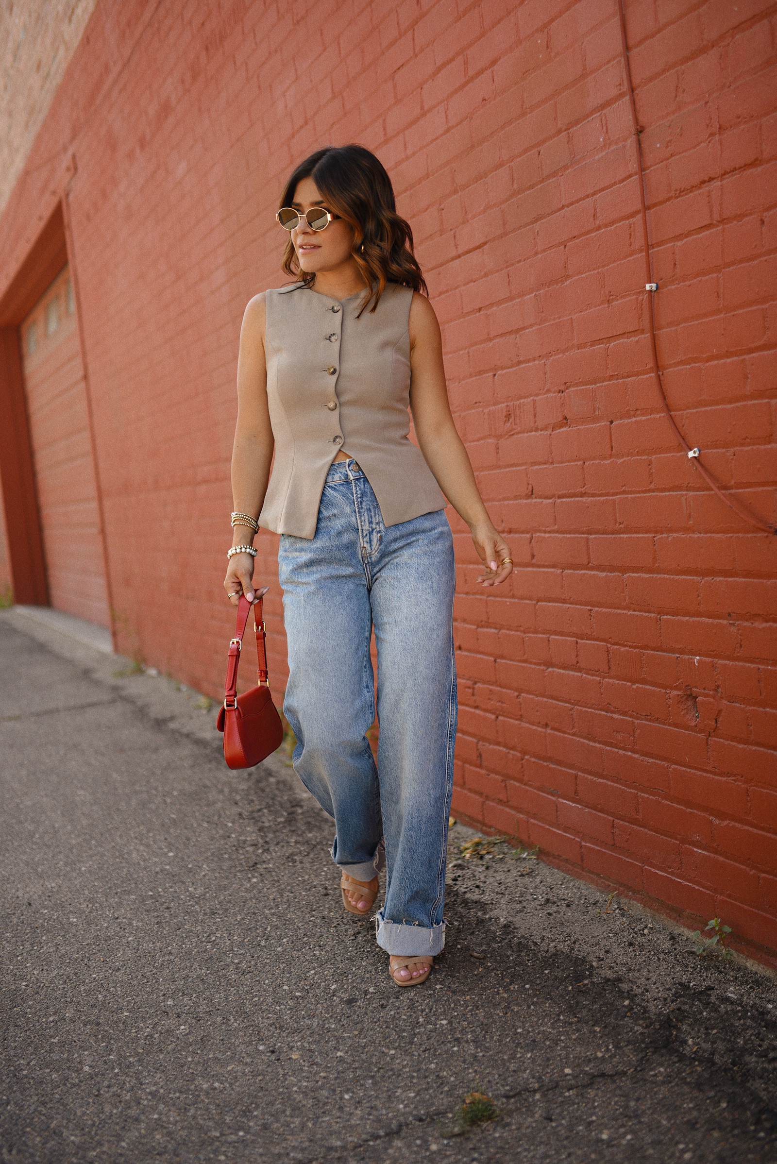 Carolina Hellal of Chic Talk wearing a Aritzia vest and blazer, Reformation wide leg jeans and Anrthropologie hand bag