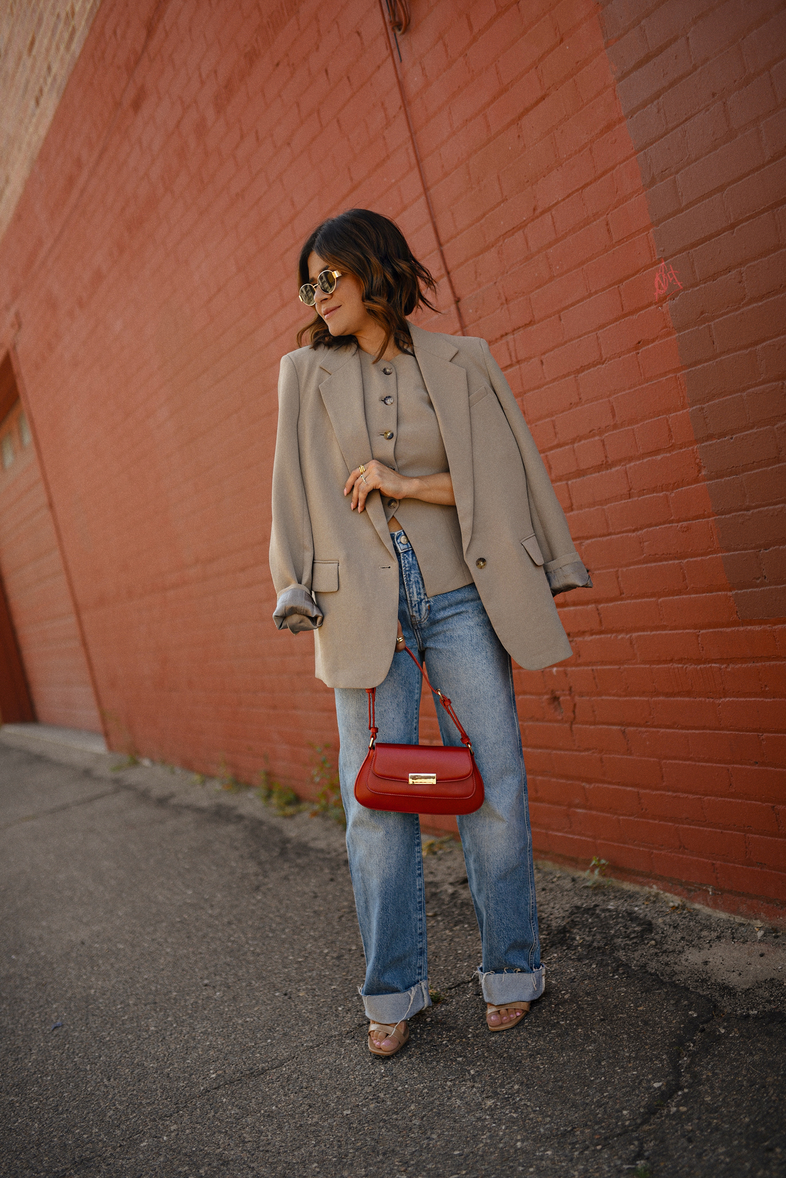 Carolina Hellal of Chic Talk wearing a Aritzia vest and blazer, Reformation wide leg jeans and Anrthropologie hand bag