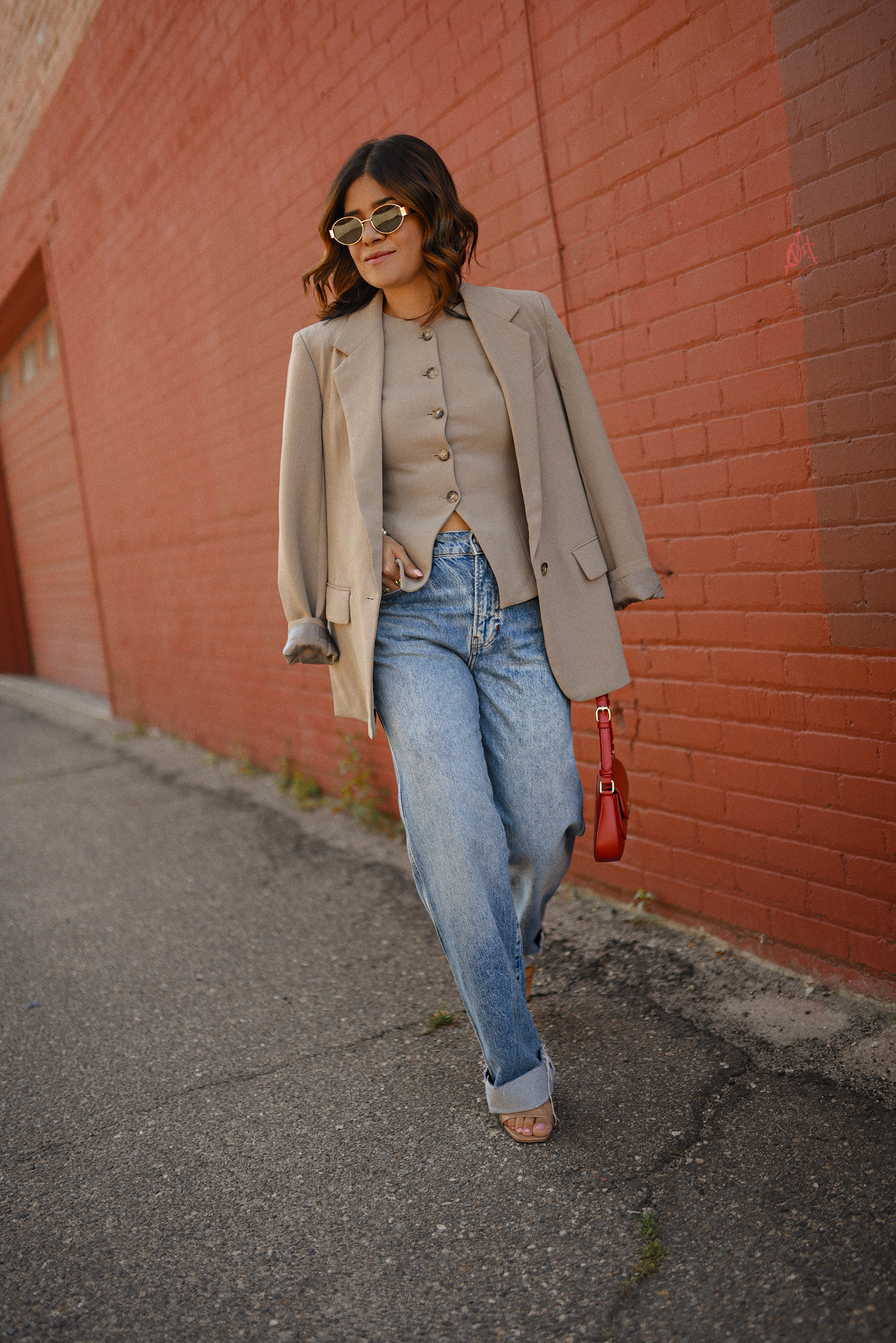 Carolina Hellal of Chic Talk wearing a Aritzia vest and blazer, Reformation wide leg jeans and Anrthropologie hand bag