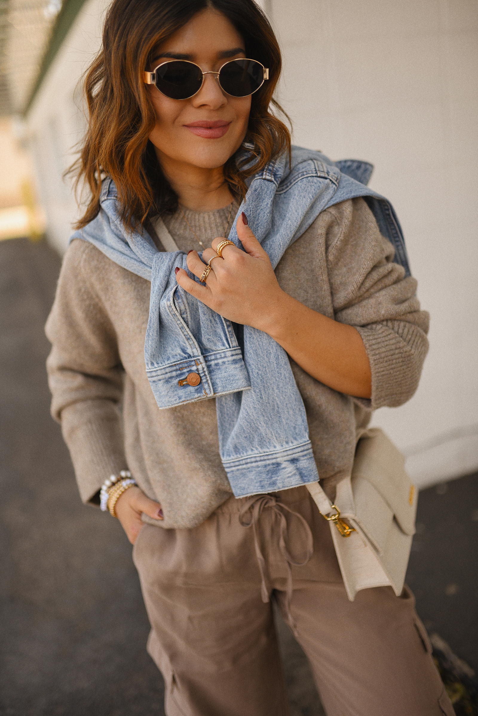 Carolina Hellal of Chic Talk wearing a cargo pants and sweater via Abercrombie, a classic jean jacket, Adidas Samba Shoes and Jacquemus Le Grand Bambino bag