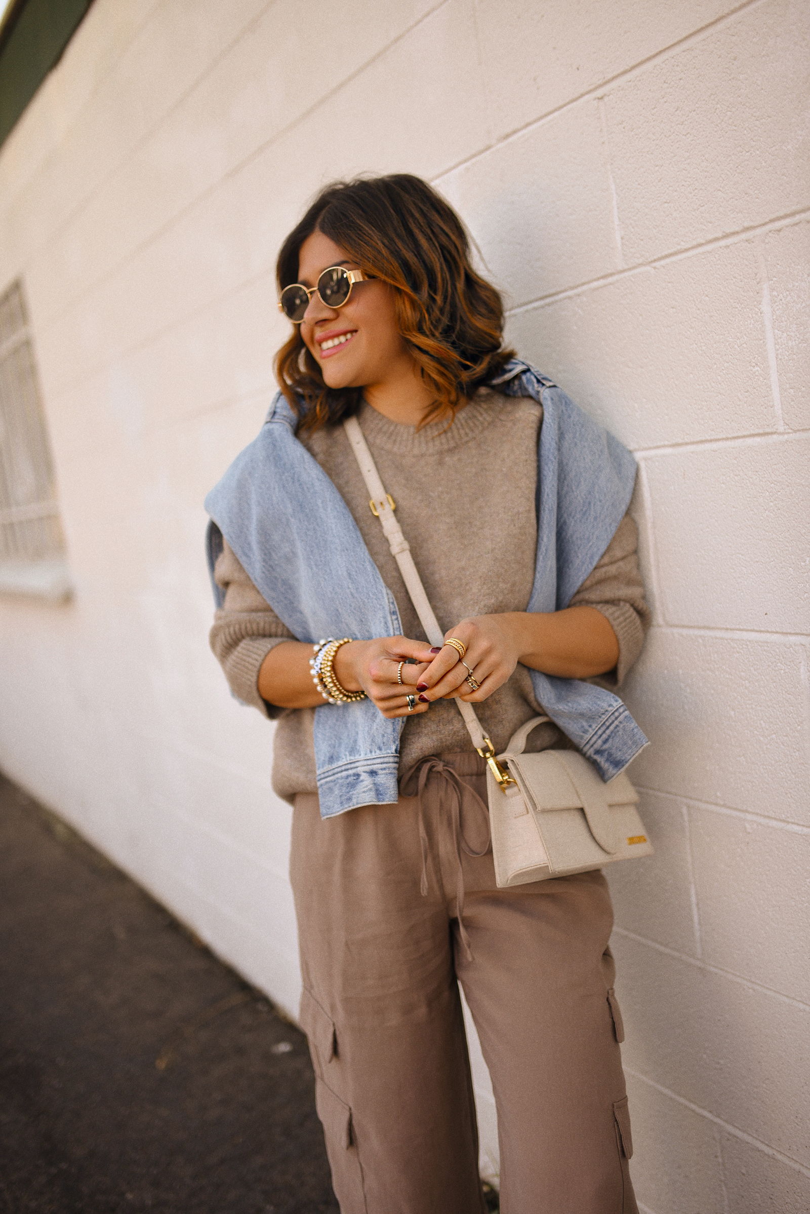 Carolina Hellal of Chic Talk wearing a cargo pants and sweater via Abercrombie, a classic jean jacket, Adidas Samba Shoes and Jacquemus Le Grand Bambino bag