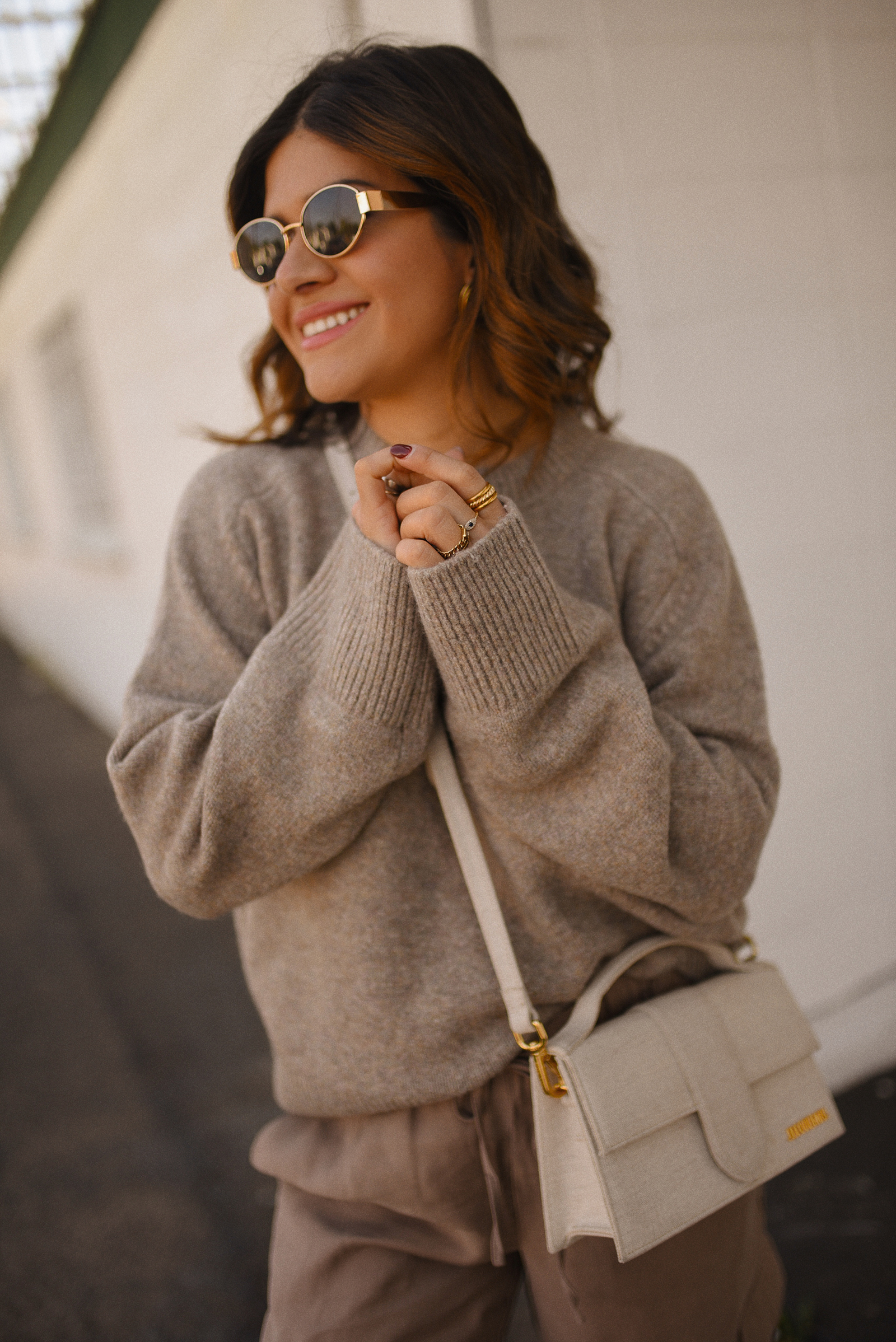 Carolina Hellal of Chic Talk wearing a cargo pants and sweater via Abercrombie, a classic jean jacket, Adidas Samba Shoes and Jacquemus Le Grand Bambino bag