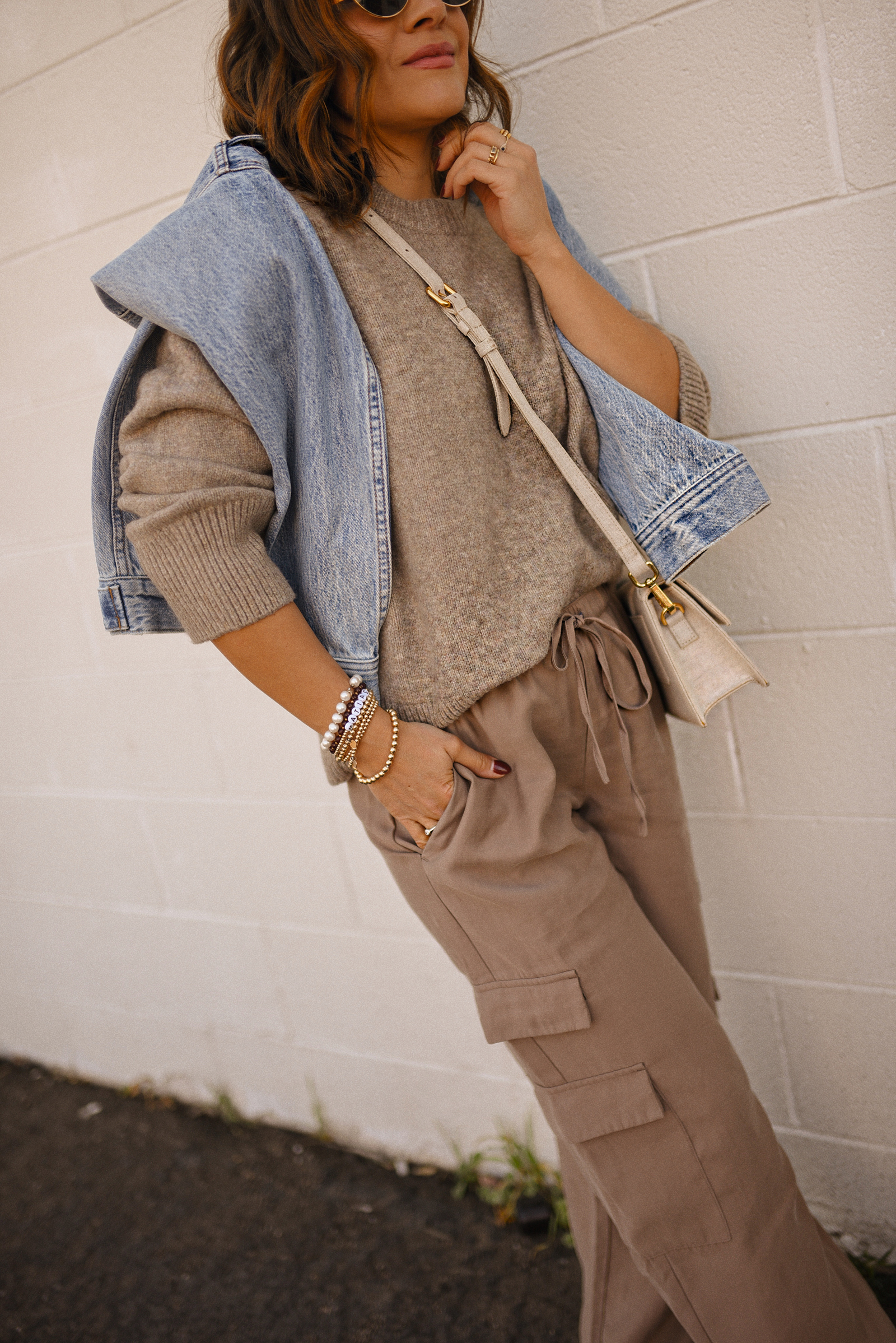 Carolina Hellal of Chic Talk wearing a cargo pants and sweater via Abercrombie, a classic jean jacket, Adidas Samba Shoes and Jacquemus Le Grand Bambino bag