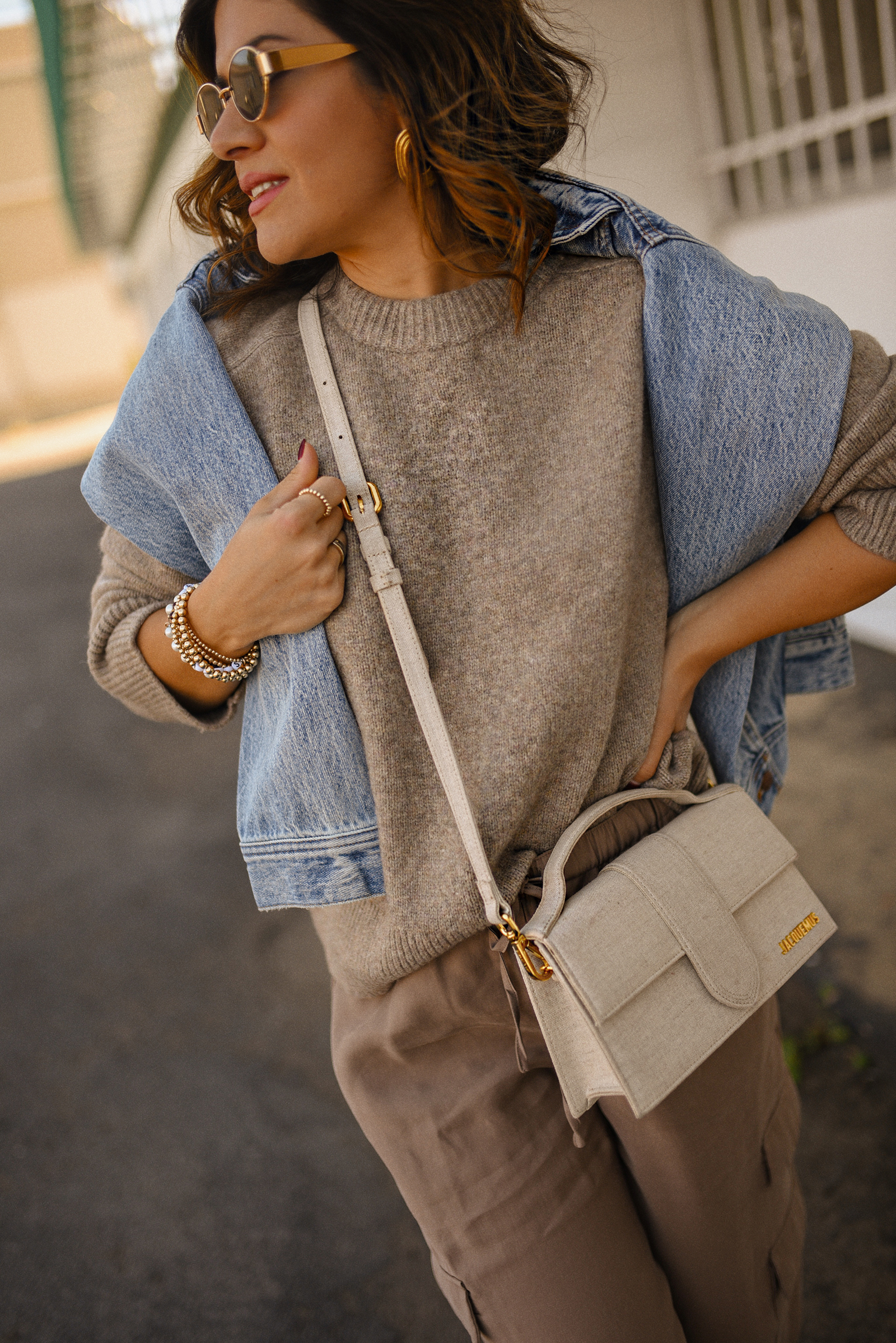 Carolina Hellal of Chic Talk wearing a cargo pants and sweater via Abercrombie, a classic jean jacket, Adidas Samba Shoes and Jacquemus Le Grand Bambino bag