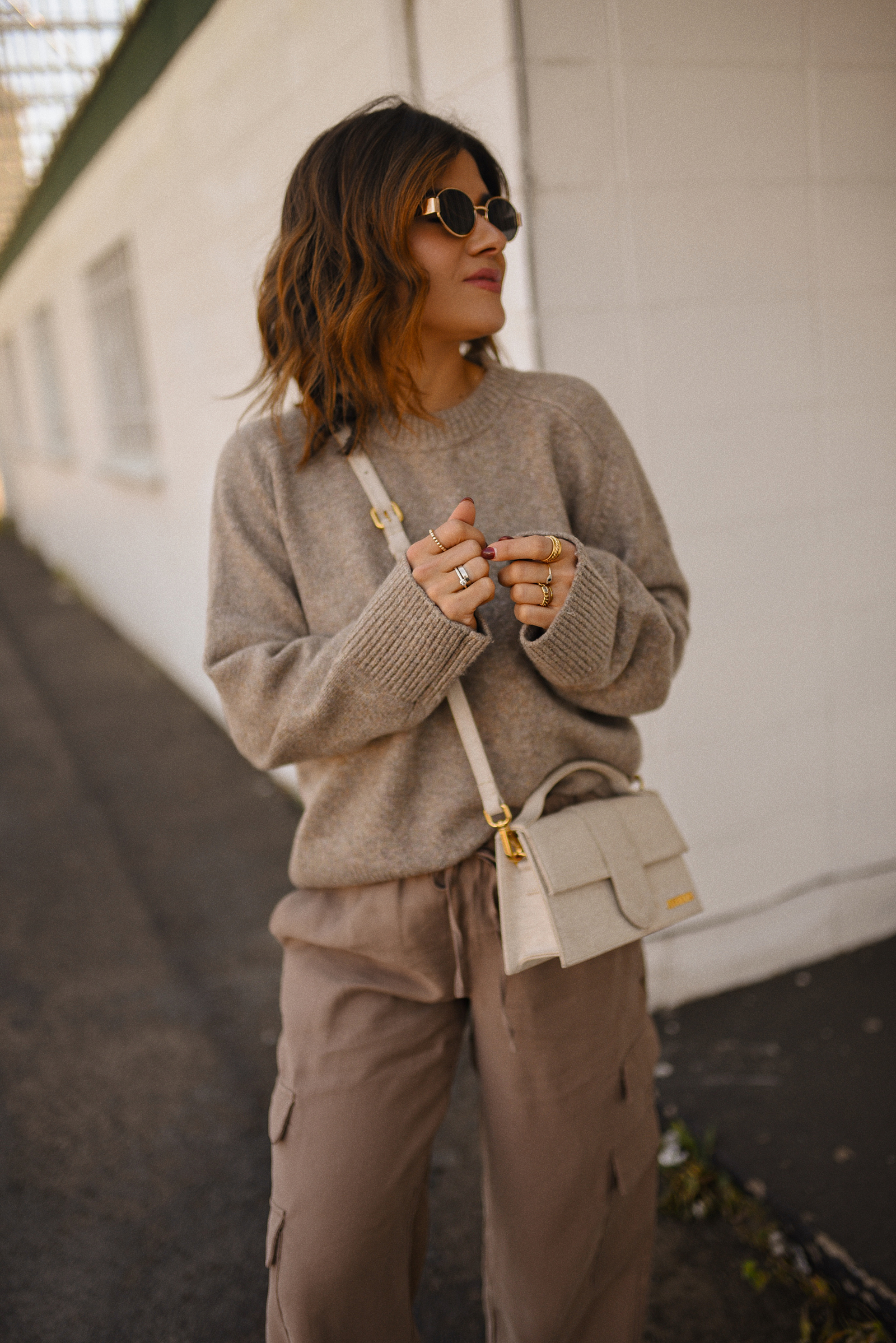 Carolina Hellal of Chic Talk wearing a cargo pants and sweater via Abercrombie, a classic jean jacket, Adidas Samba Shoes and Jacquemus Le Grand Bambino bag