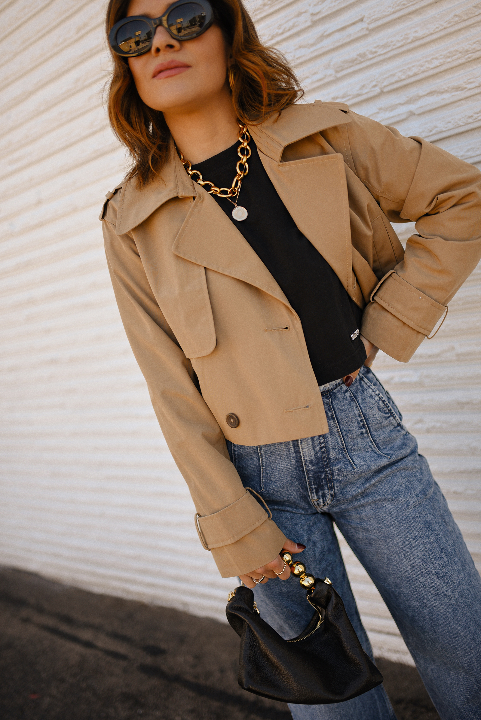 Carolina Hellal of Chic Talk wearing a short trench coat via Abercrombie, tshirt and jeans from Hudson jeans, Nordstrom animal print pumps and Amazon black handbag