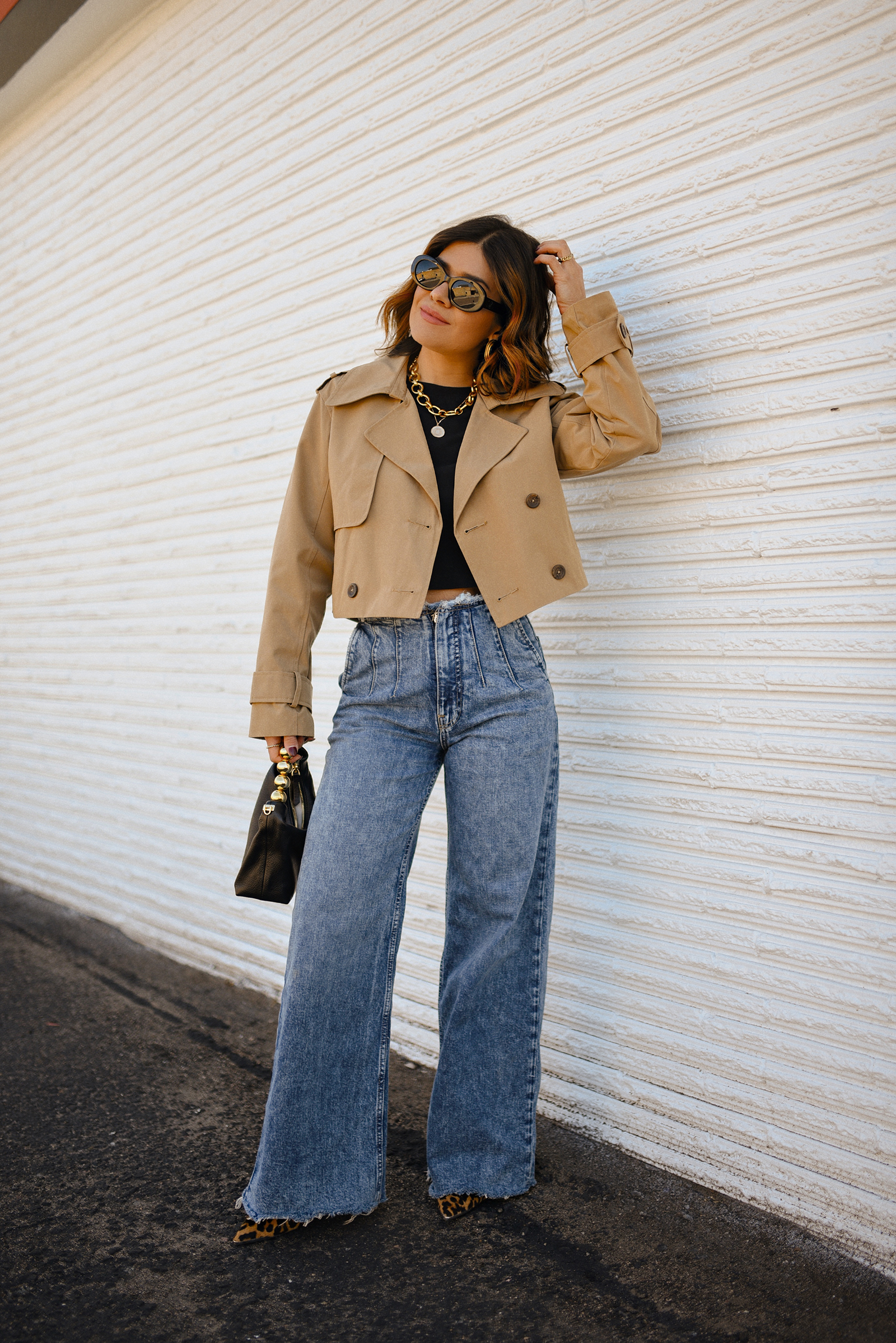 Carolina Hellal of Chic Talk wearing a short trench coat via Abercrombie, tshirt and jeans from Hudson jeans, Nordstrom animal print pumps and Amazon black handbag