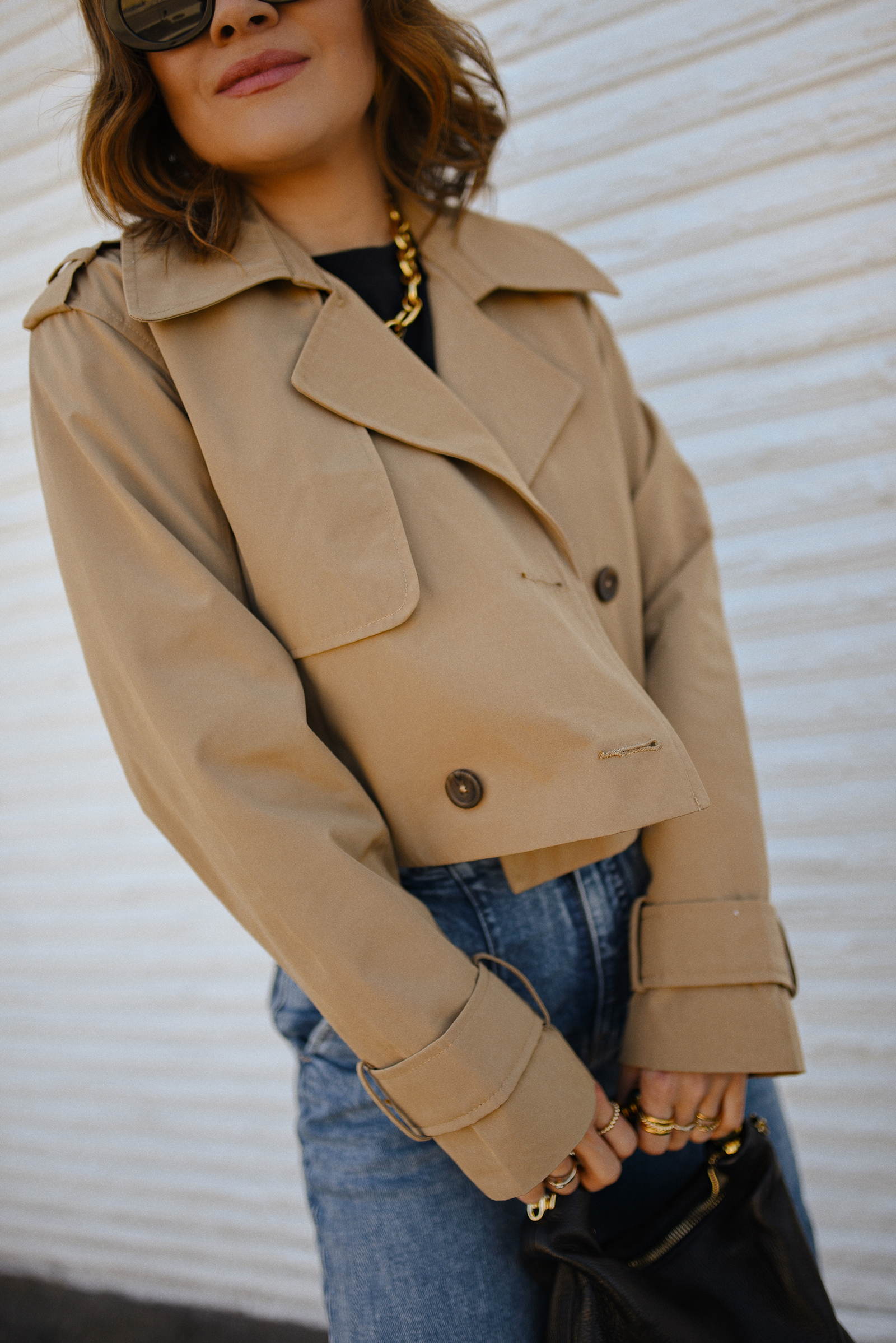 Carolina Hellal of Chic Talk wearing a short trench coat via Abercrombie, tshirt and jeans from Hudson jeans, Nordstrom animal print pumps and Amazon black handbag