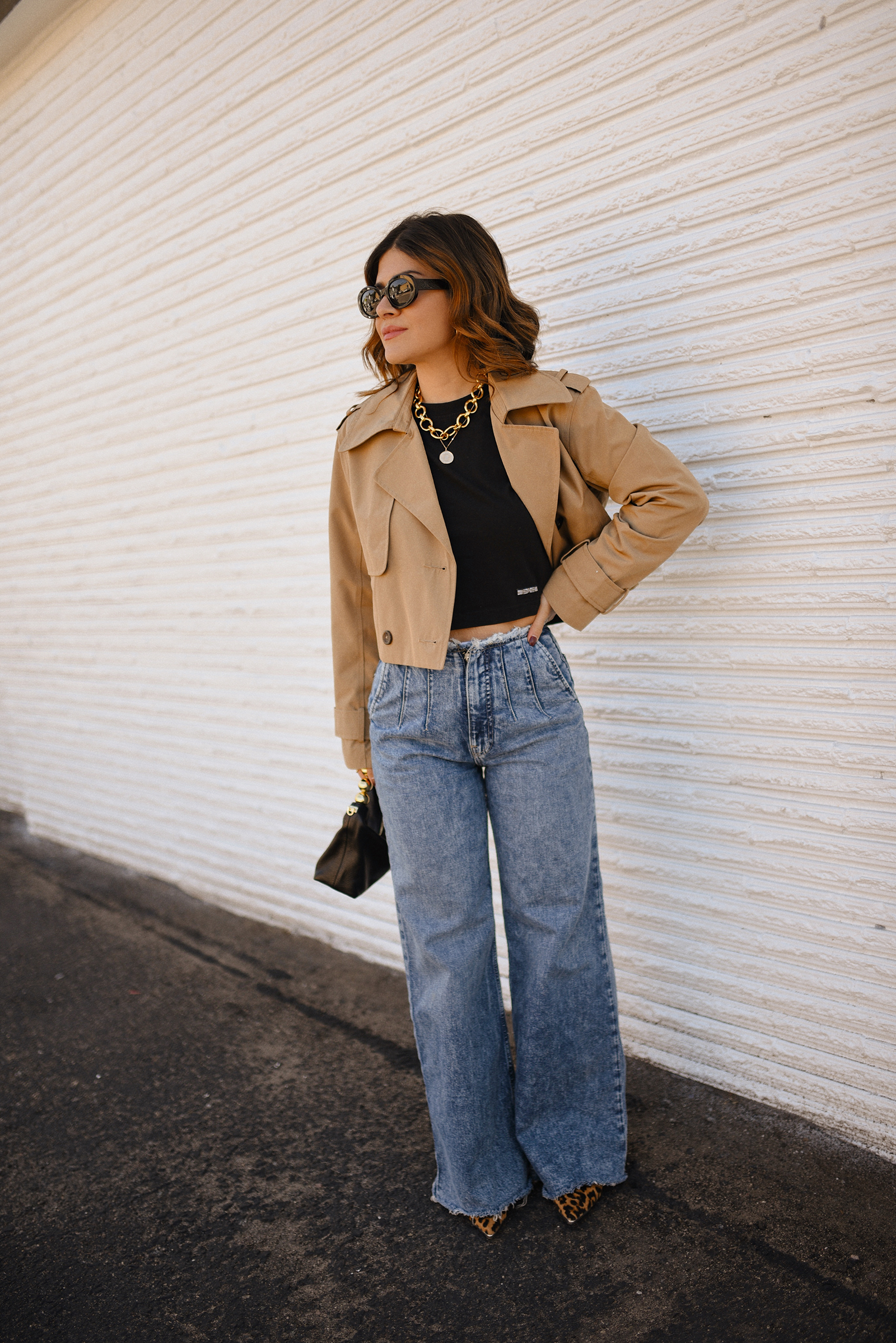 Carolina Hellal of Chic Talk wearing a short trench coat via Abercrombie, tshirt and jeans from Hudson jeans, Nordstrom animal print pumps and Amazon black handbag