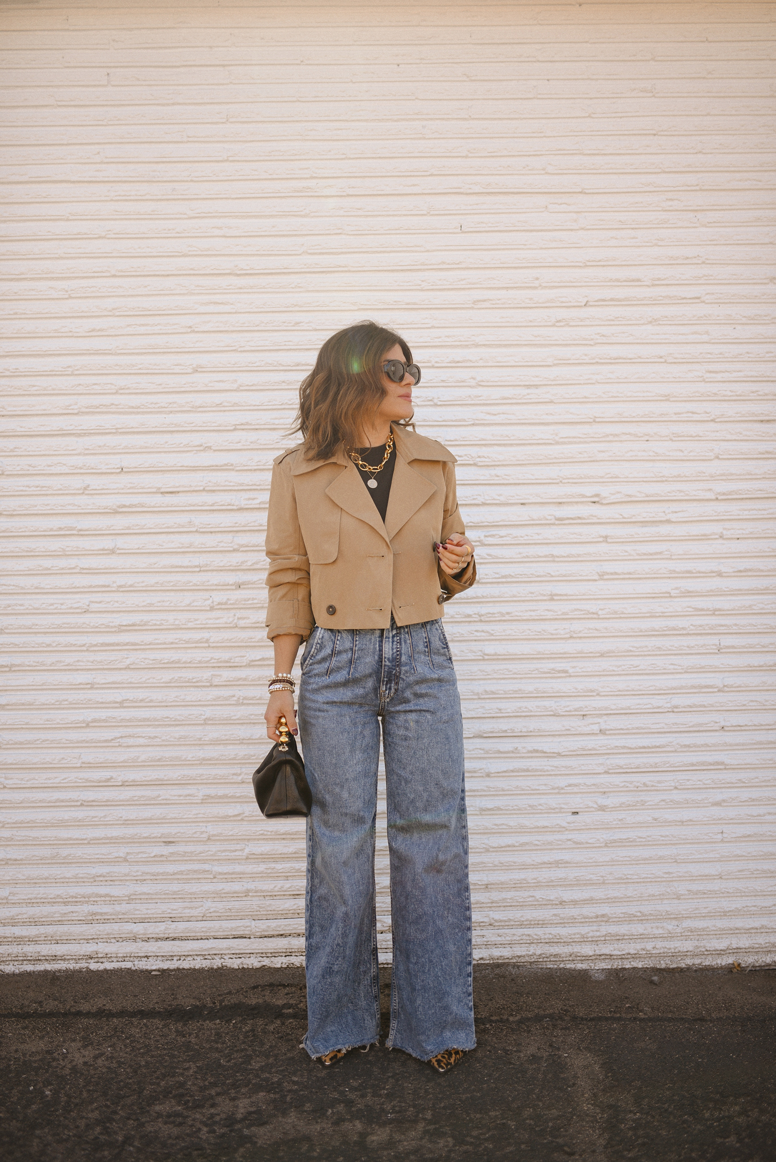 Carolina Hellal of Chic Talk wearing a short trench coat via Abercrombie, tshirt and jeans from Hudson jeans, Nordstrom animal print pumps and Amazon black handbag